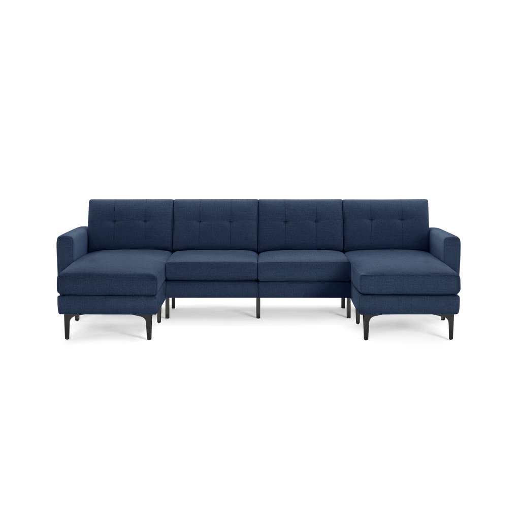 Modern L-shaped sectional sofa in dark blue fabric with tufted back cushions and black metal legs, offering spacious seating.