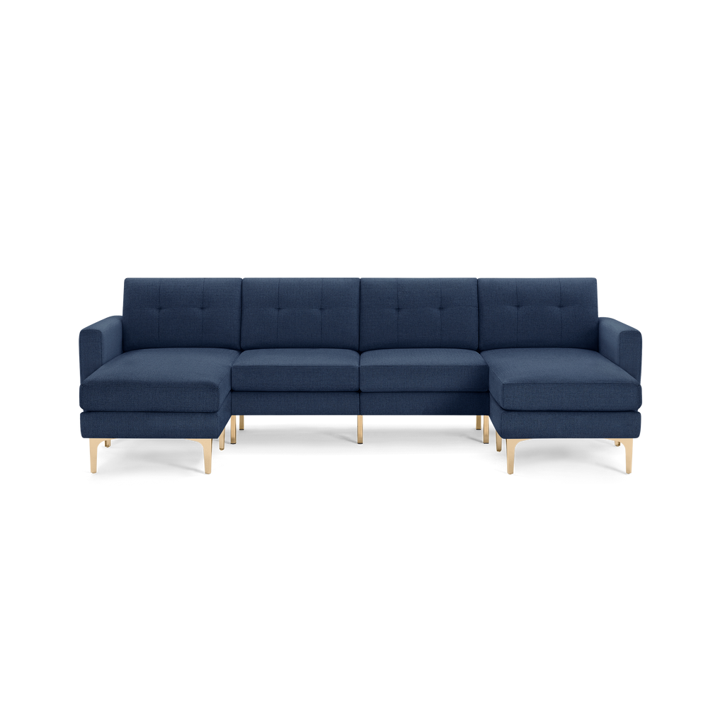 Modern sectional sofa with navy blue fabric upholstery, tufted back cushions, gold metal legs, left and right chaise ends.