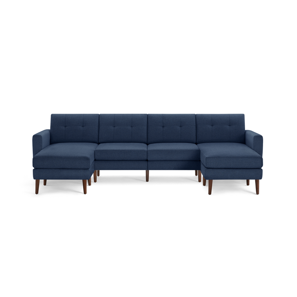Modern navy blue sectional sofa with tufted back cushions, wooden tapered legs, and symmetrical chaise lounges on both ends.