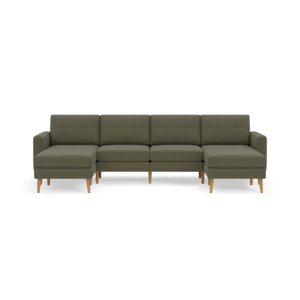 Moss green modern sectional sofa with tufted cushions, wooden legs, and two chaise lounge ends against a black background.