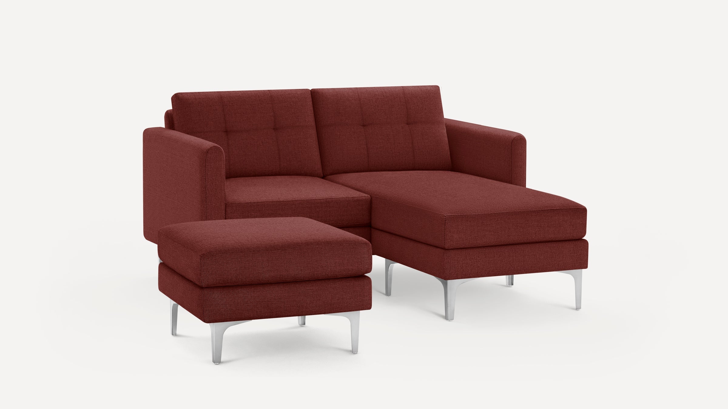 Modern burgundy fabric sectional sofa with tufted cushions, metal legs, and matching ottoman on white background.