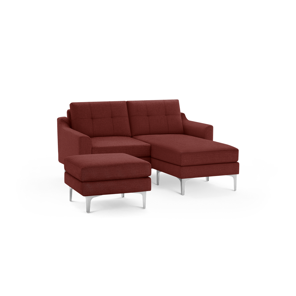 Modern red fabric sectional sofa with tufted back cushions, metal legs, and a matching ottoman.