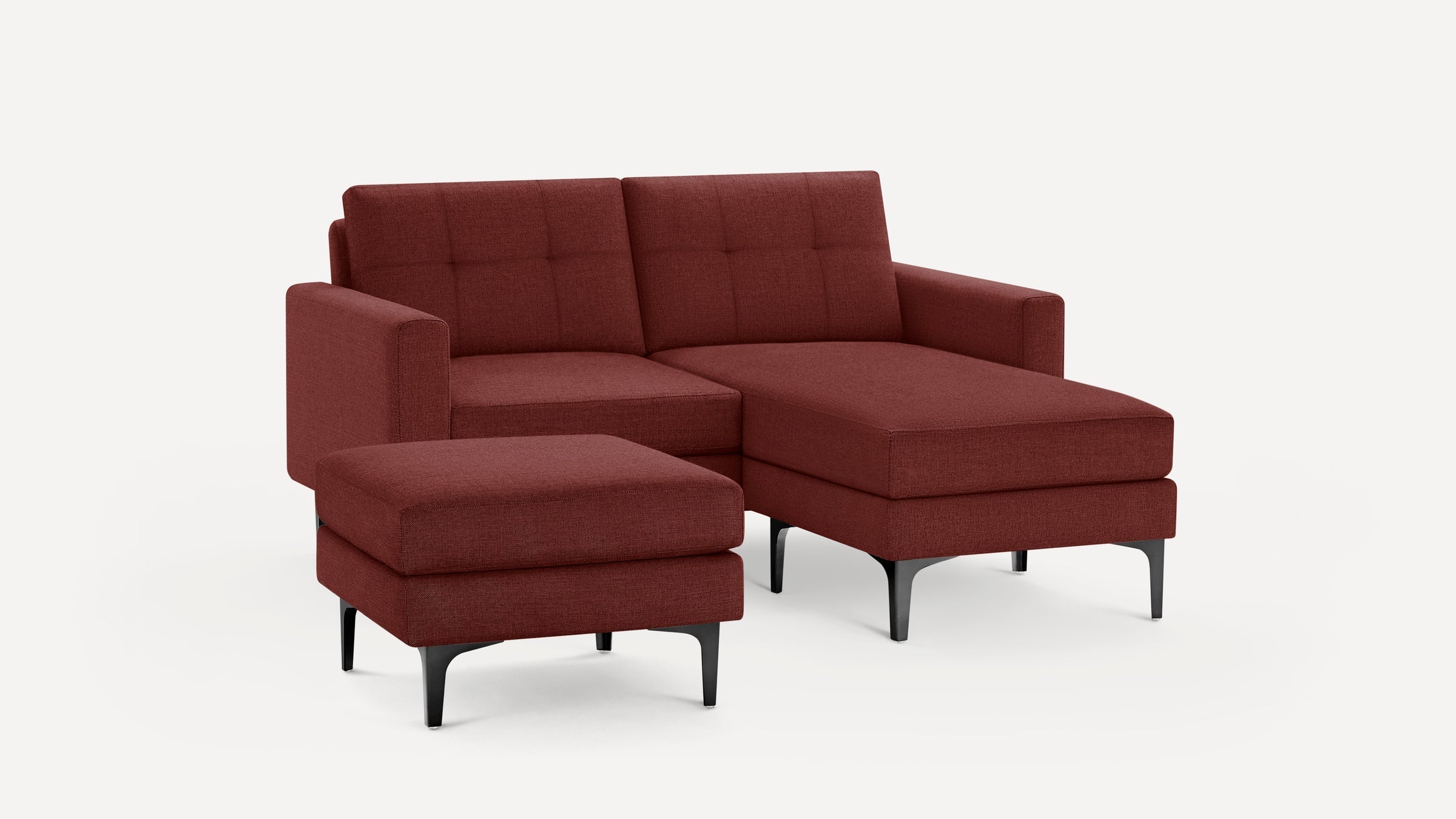 Modern L-shaped sectional sofa in dark red fabric with tufted back cushions and black metal legs, including a matching ottoman.