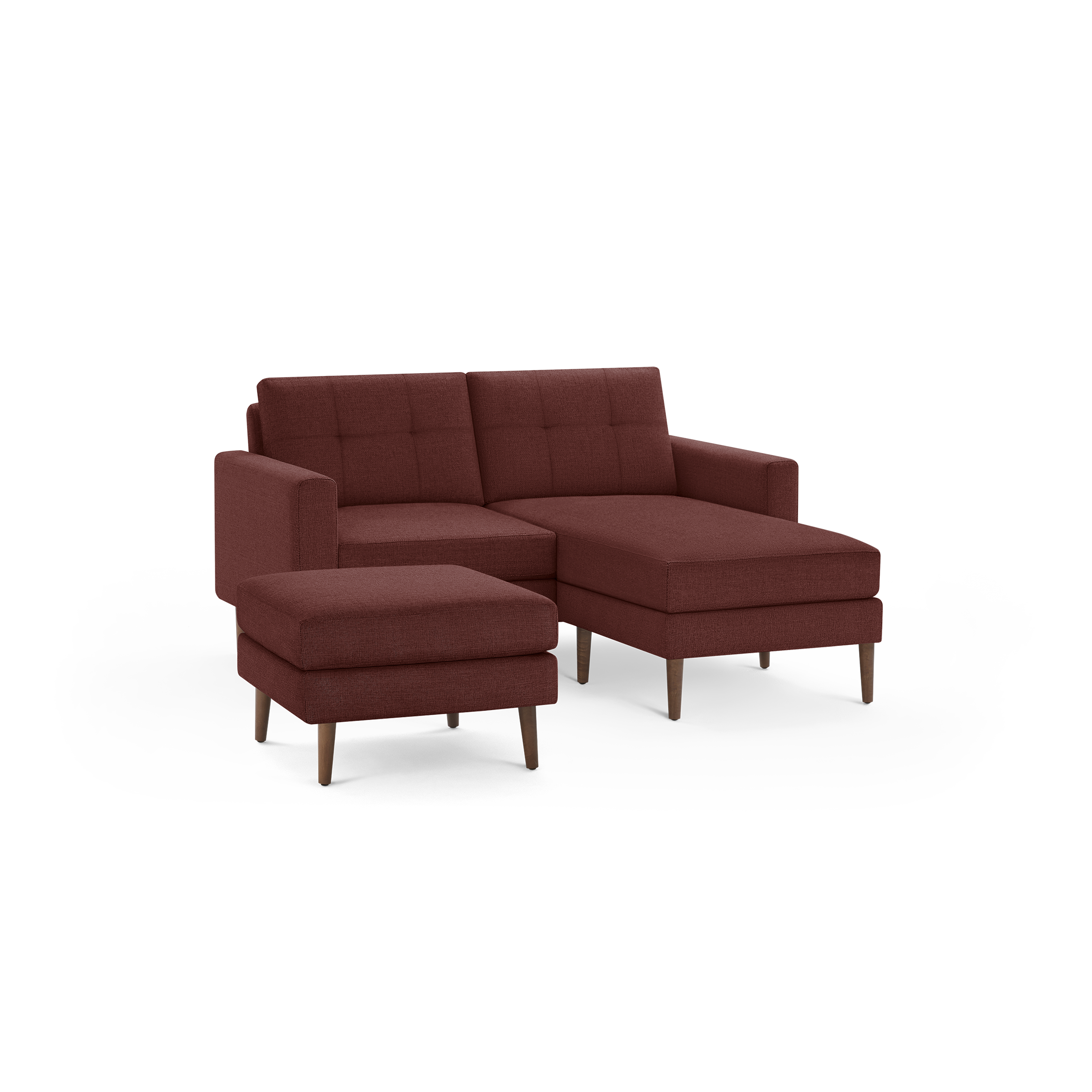 Modern rust-colored sectional sofa with tufted back cushions, wooden legs, and matching ottoman on black background.