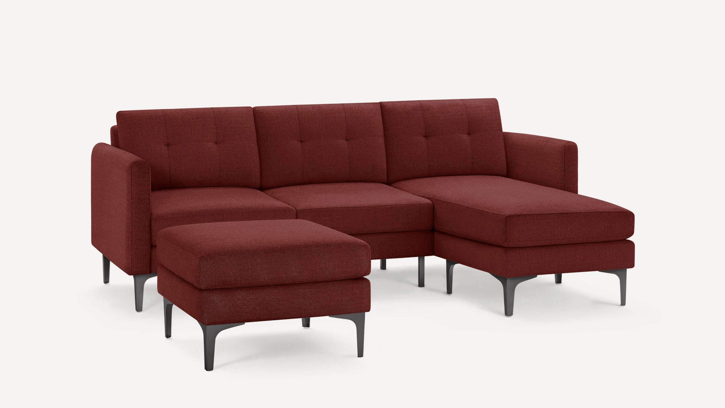 Modern sectional sofa set with tufted back cushions, deep red fabric upholstery, metal legs, and a matching ottoman on a white background.