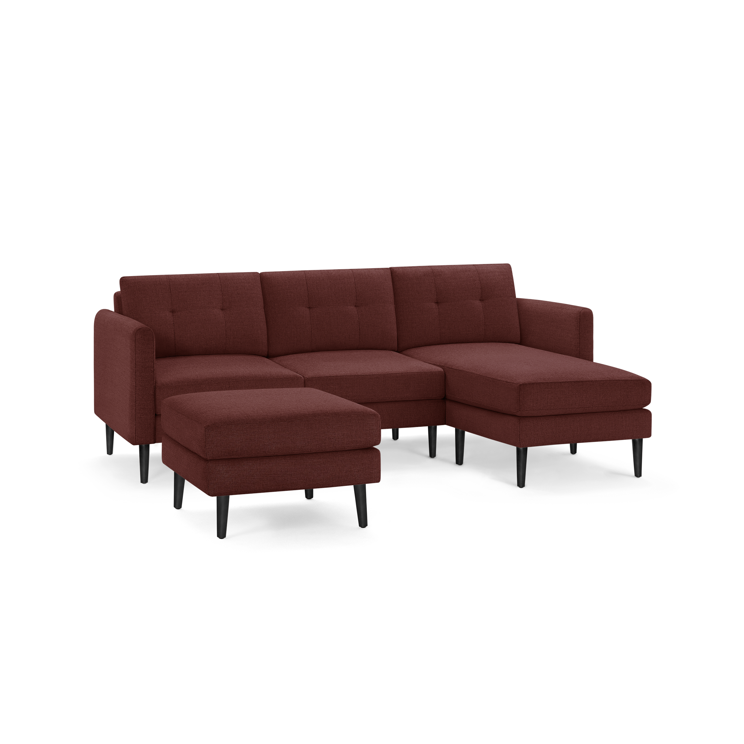 Modern sectional sofa with chaise lounge and matching ottoman, upholstered in deep red fabric with black wooden legs.