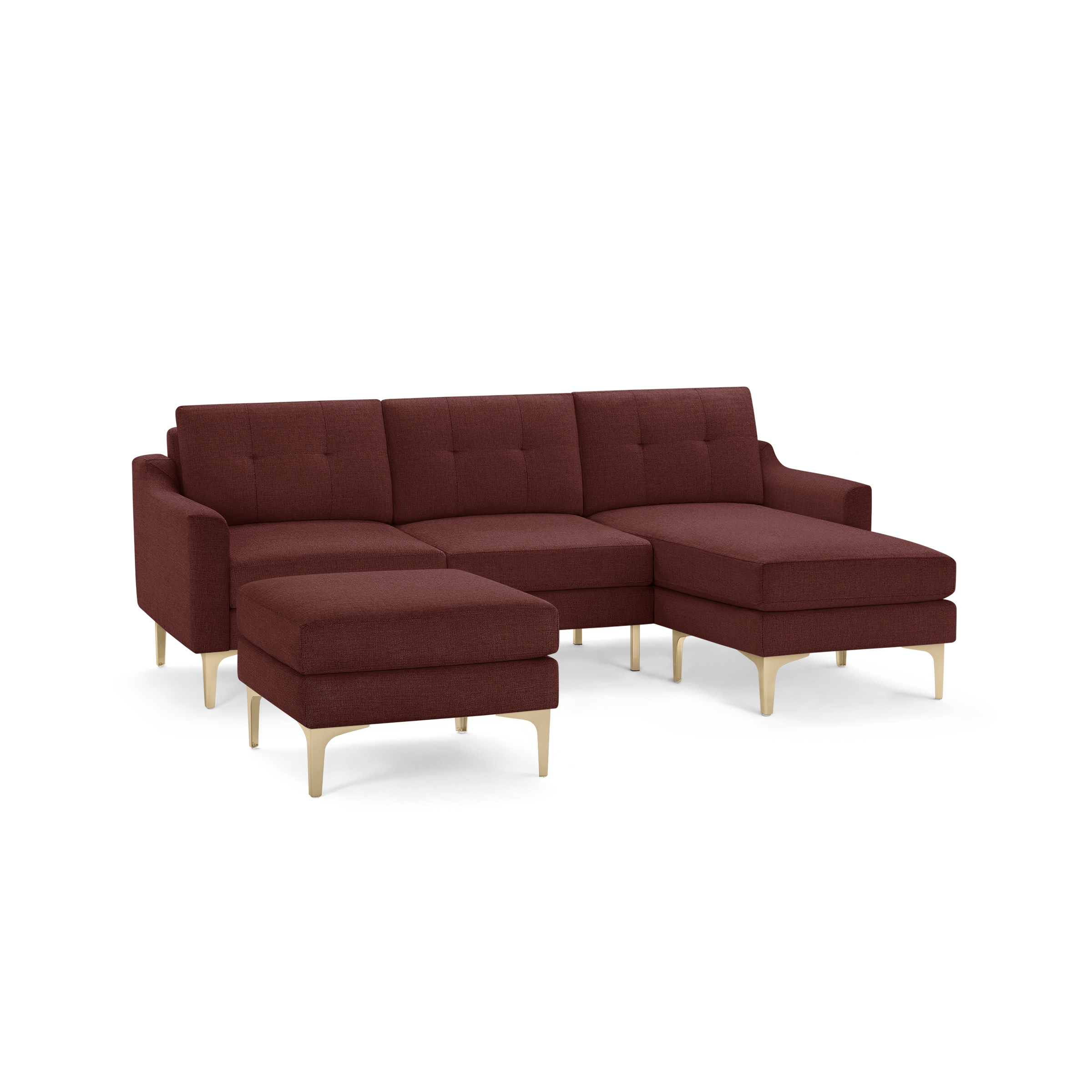 Modern sectional sofa with deep red fabric upholstery, tufted back cushions, and light wooden legs, including a matching ottoman.