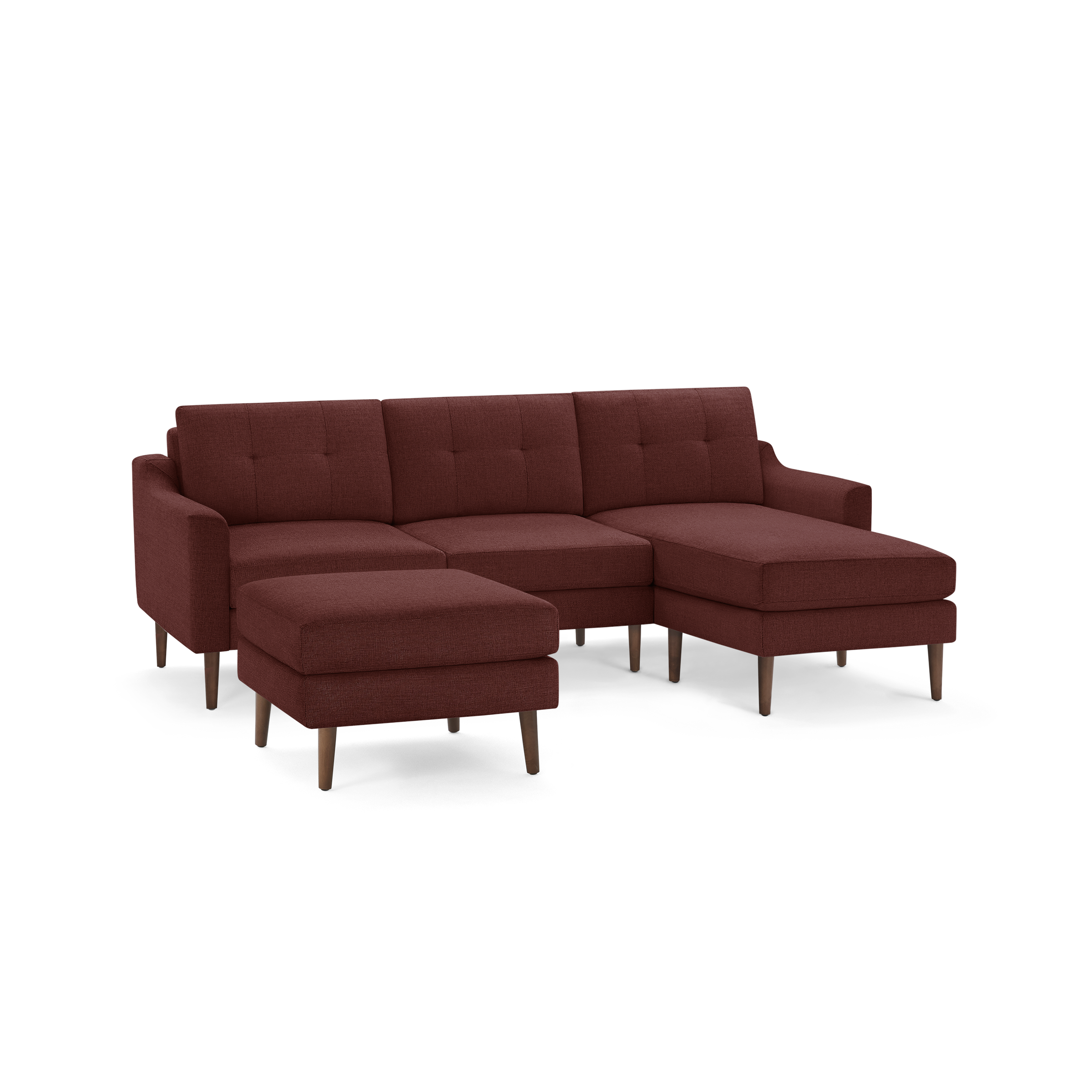 Rust-colored upholstered sectional sofa with tufted back cushions, a matching ottoman, and wooden tapered legs.