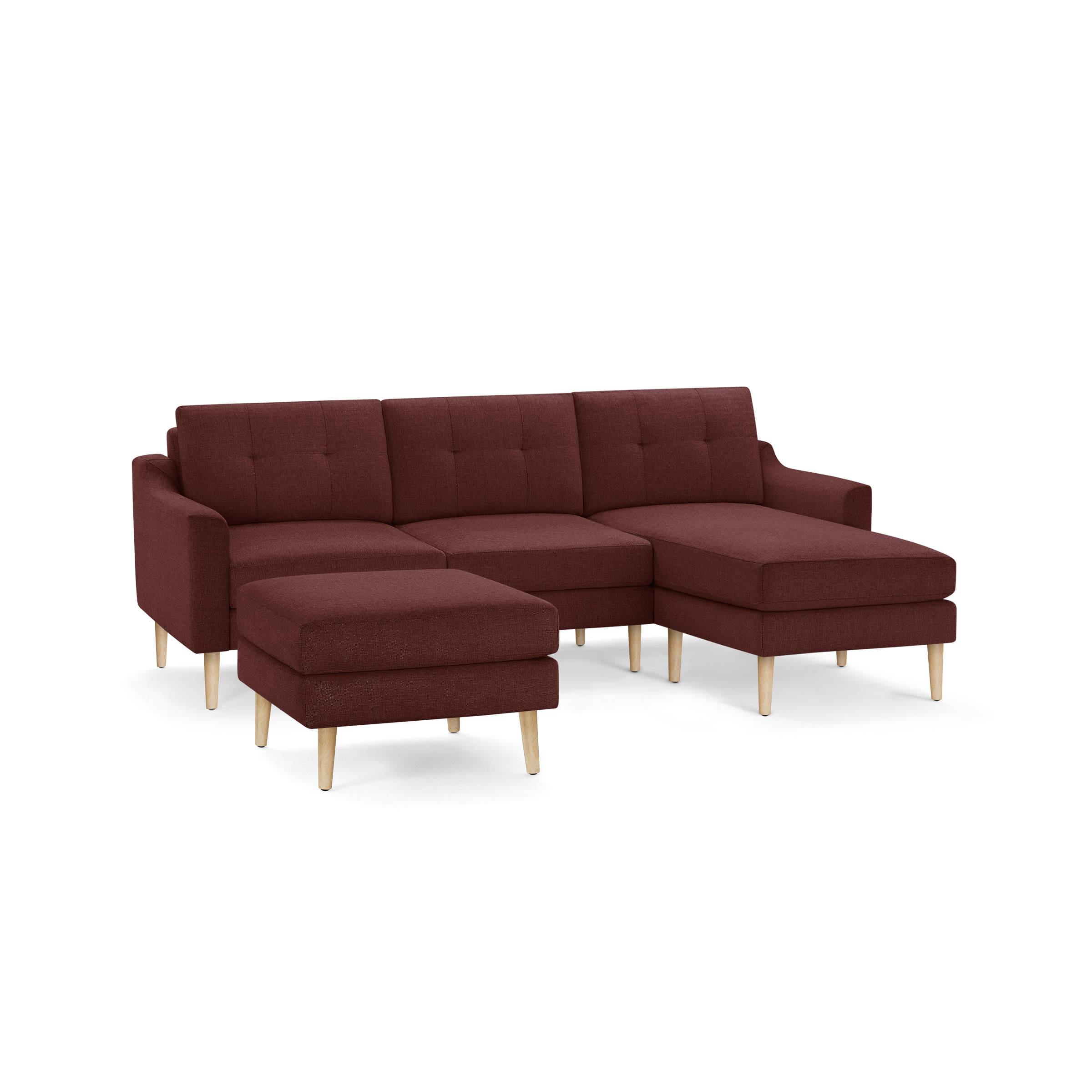 Modern L-shaped sectional sofa in deep red fabric with tufted cushions and light wooden tapered legs, including a matching ottoman.