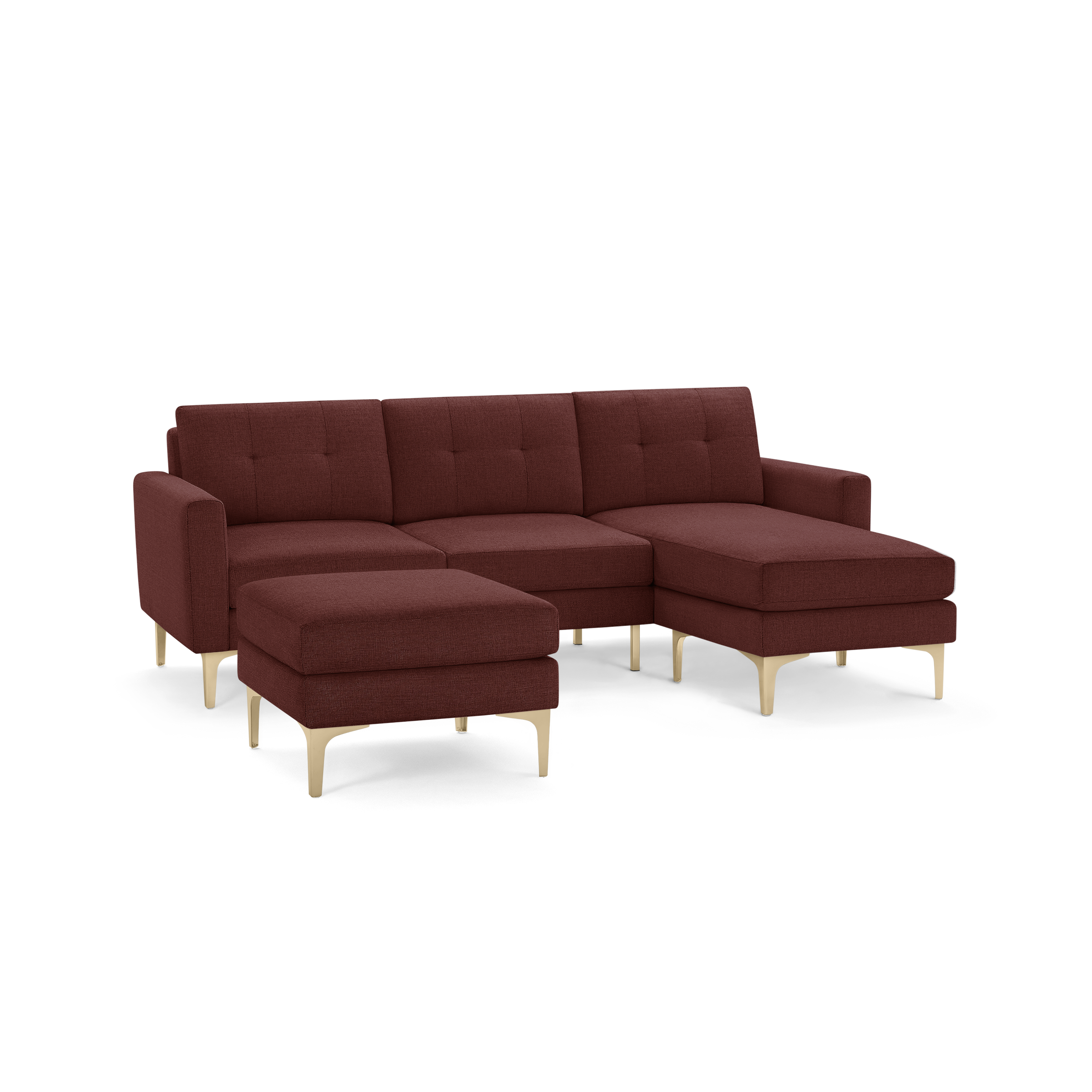 Modern sectional sofa with chaise and matching ottoman, upholstered in deep red fabric with light wooden legs.
