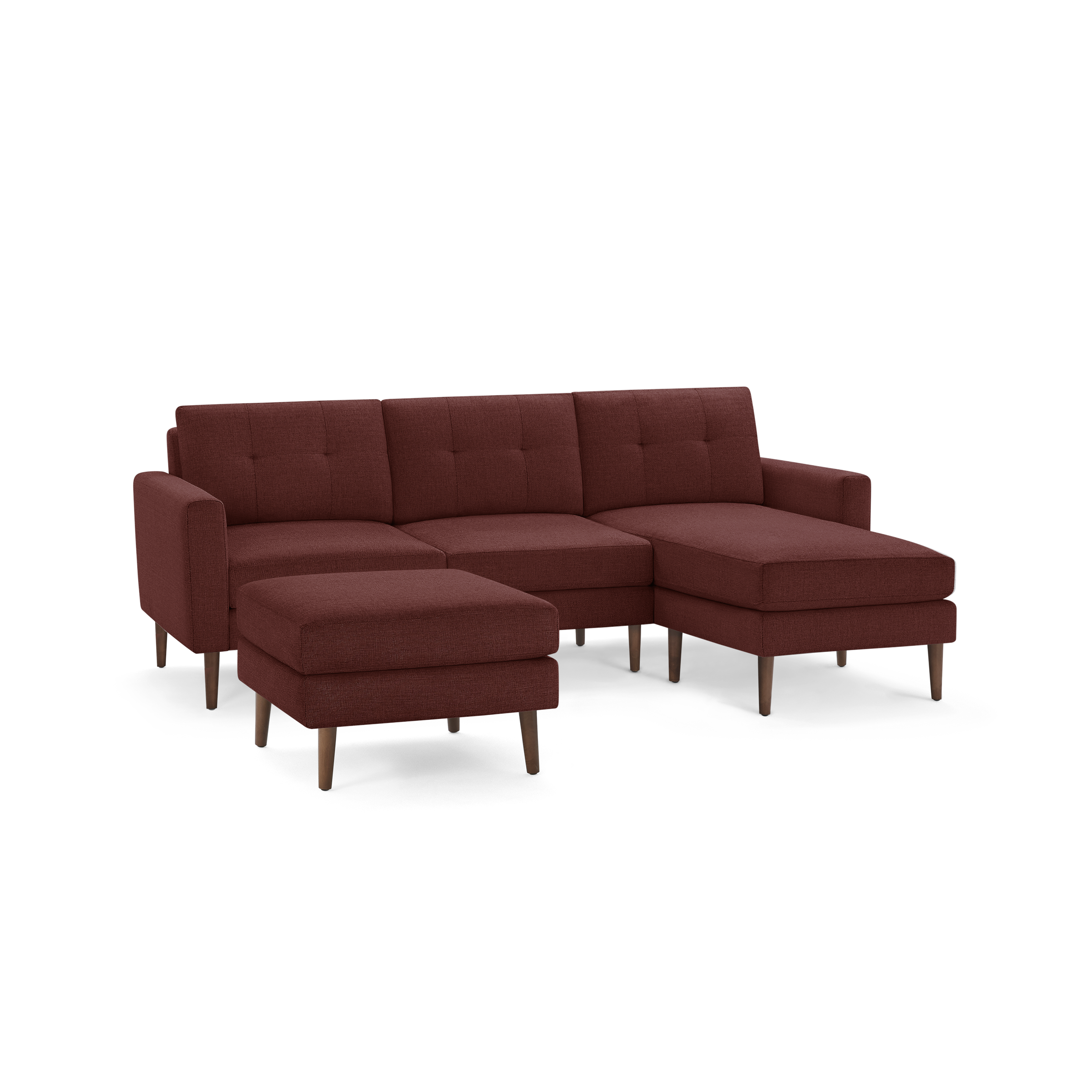 Mid-century modern sectional sofa with chaise and ottoman, upholstered in dark red fabric with wooden legs.