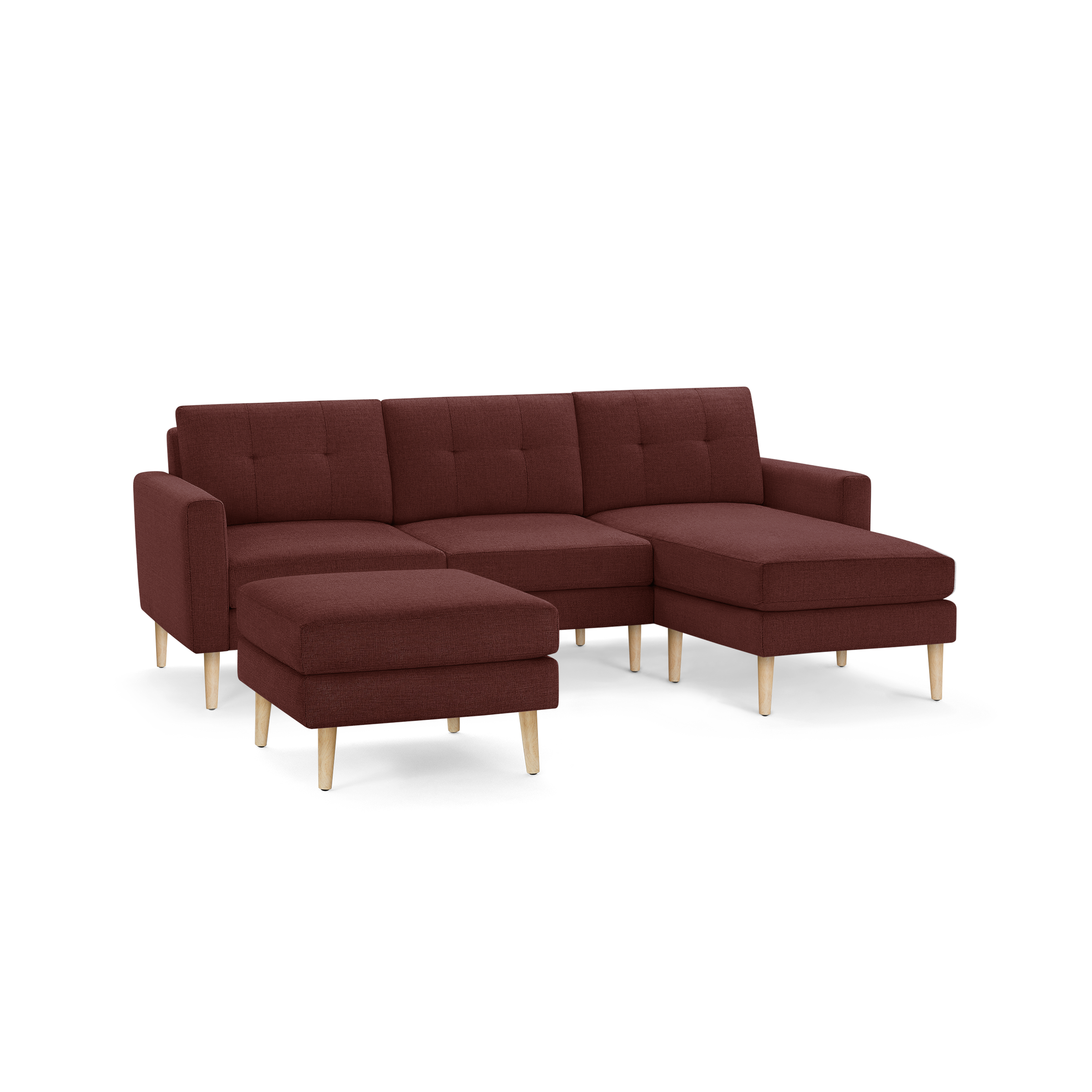 Modern sectional sofa with chaise lounge and matching ottoman, upholstered in deep red fabric with wooden legs.