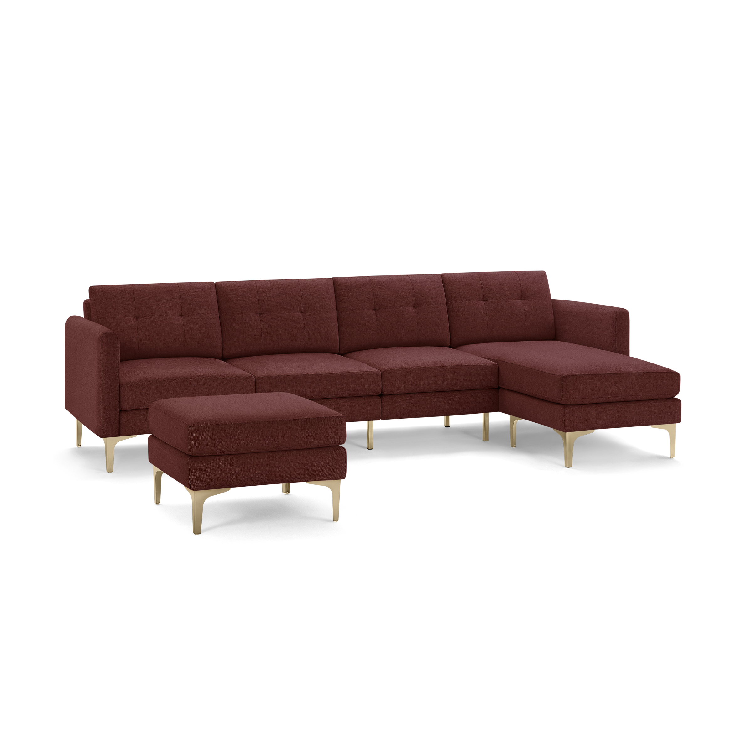 Mid-century modern sectional sofa in deep red fabric with tufted cushions, gold metal legs, and matching ottoman.