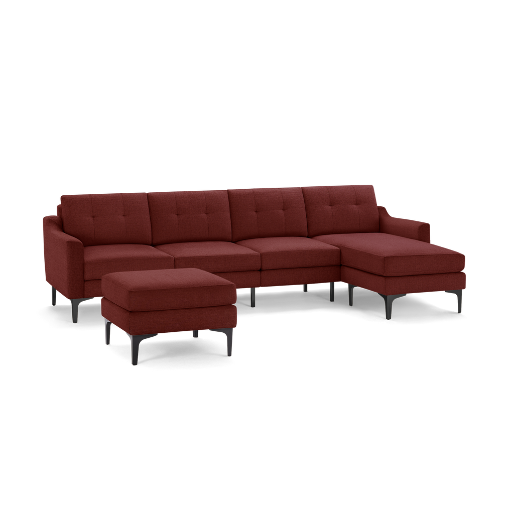 Modern sectional sofa in deep red fabric with tufted cushions, black metal legs, and matching ottoman.