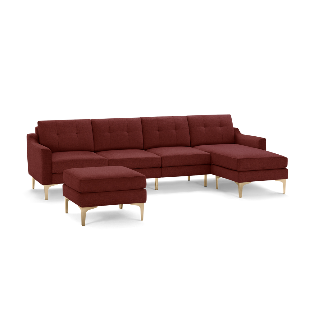 Modern sectional sofa set in deep red fabric with tufted back cushions, gold-colored angled legs, and a matching ottoman.