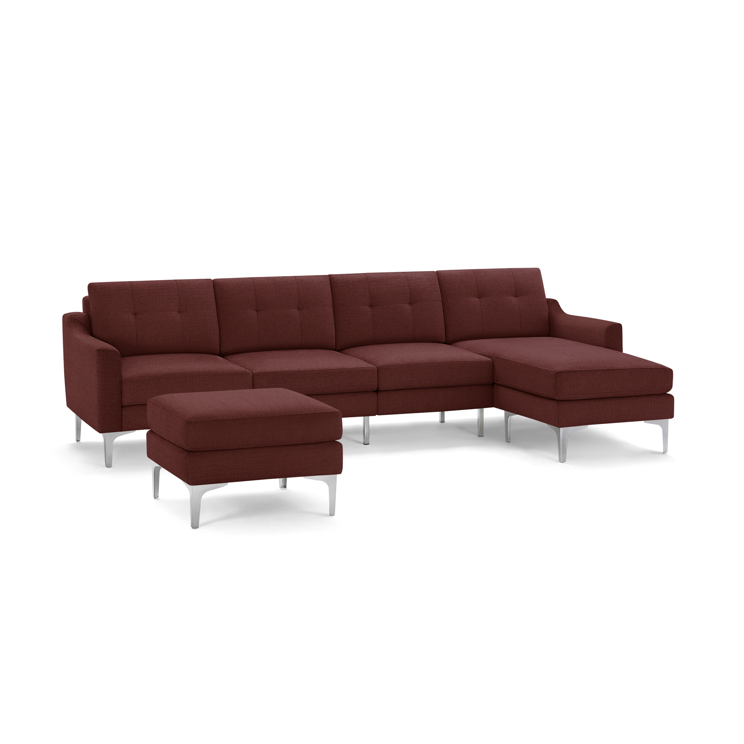 Modern sectional sofa in deep red fabric with tufted cushions, metal legs, and a matching ottoman.