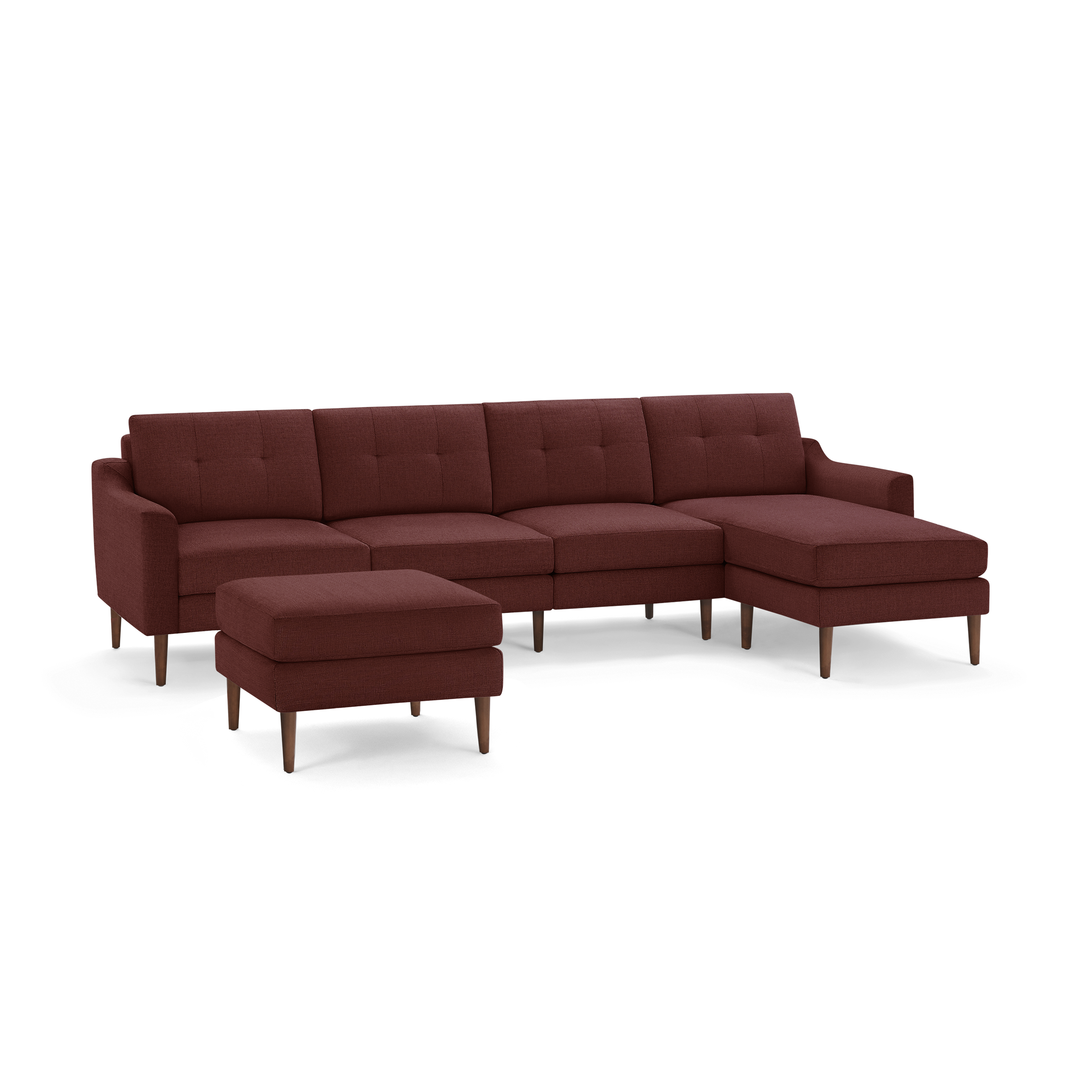 Mid-century modern sectional sofa in rust fabric with tufted cushions, wide armrests, wooden tapered legs, and matching ottoman.