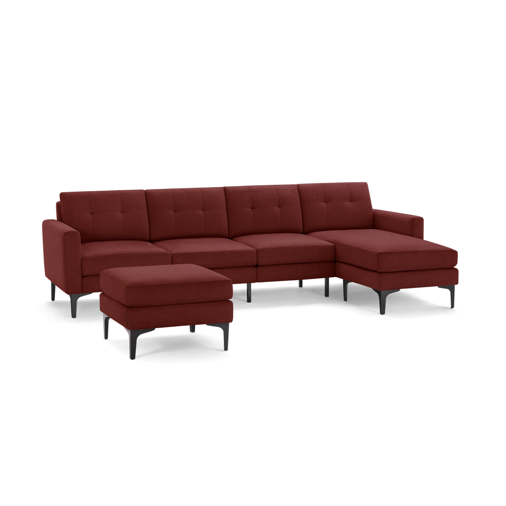 Modern sectional sofa in deep red fabric with clean lines, tufted cushions, metal legs, and a matching ottoman.