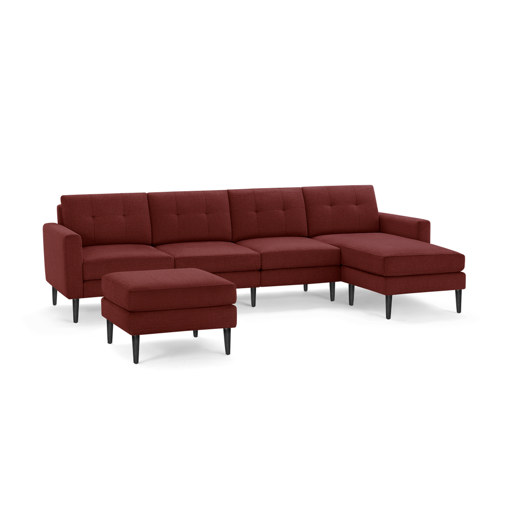 Modern sectional sofa in deep red fabric with button-tufted back cushions, black tapered legs, and an accompanying ottoman.