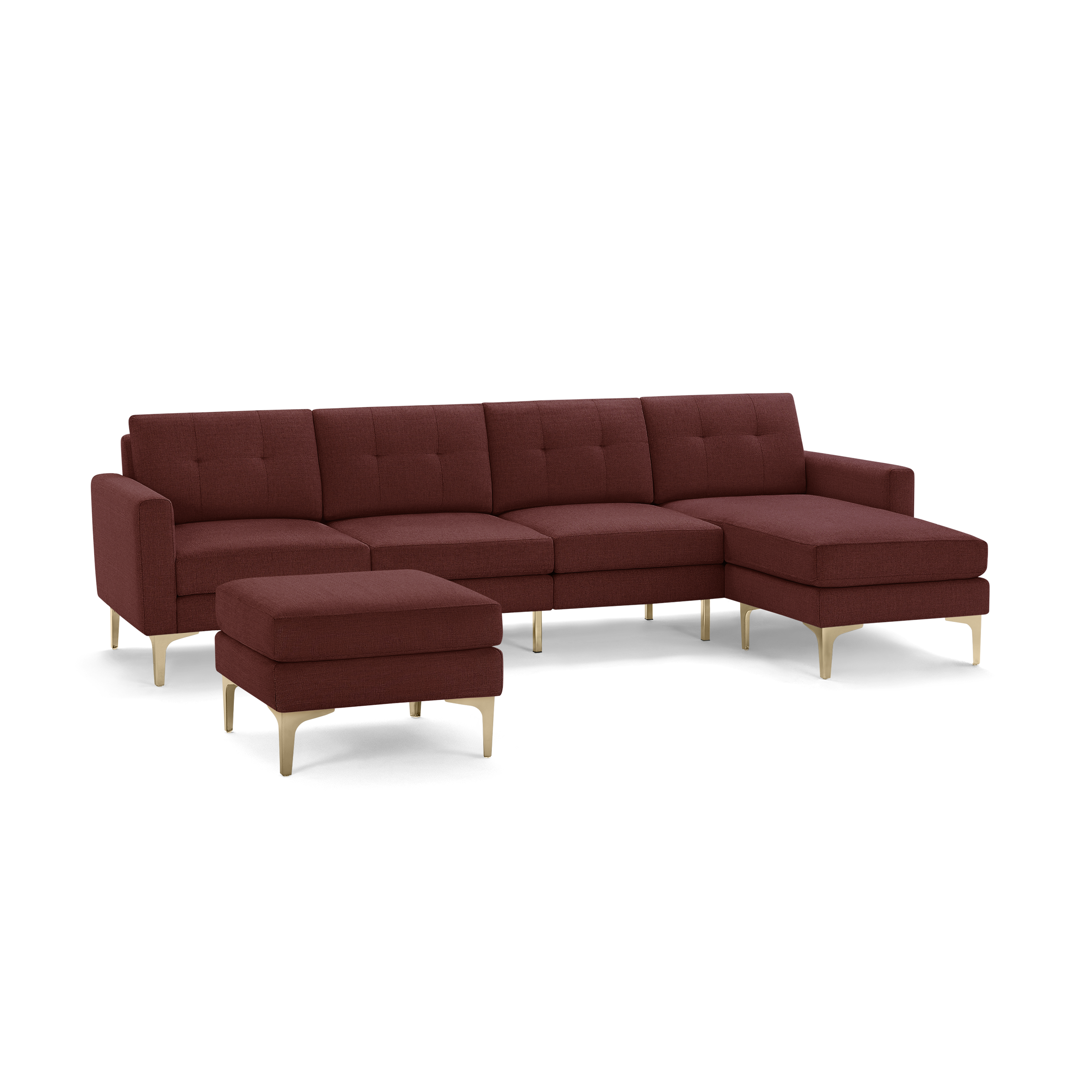 Modern L-shaped sectional sofa with deep red fabric upholstery, button-tufted back cushions, matching ottoman, and gold-toned metal legs.