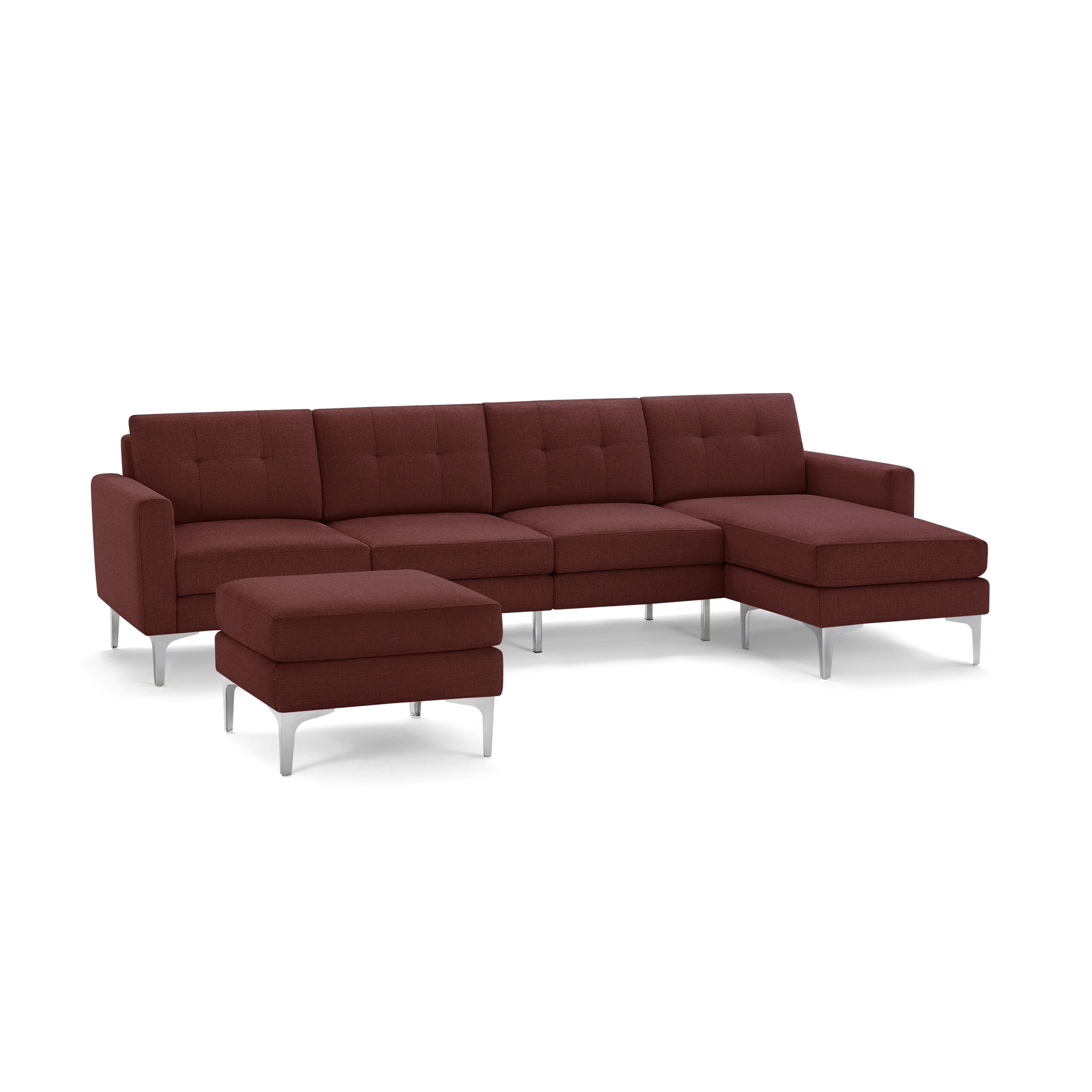Modern sectional sofa in deep red fabric with tufted back cushions, metal legs, and matching ottoman.