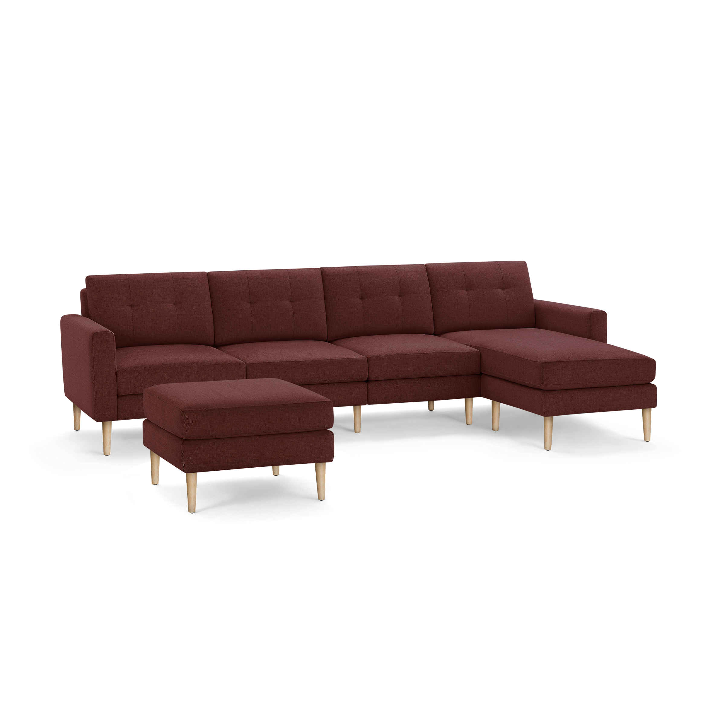 Modern sectional sofa with chaise and ottoman, upholstered in deep red fabric with wooden legs.