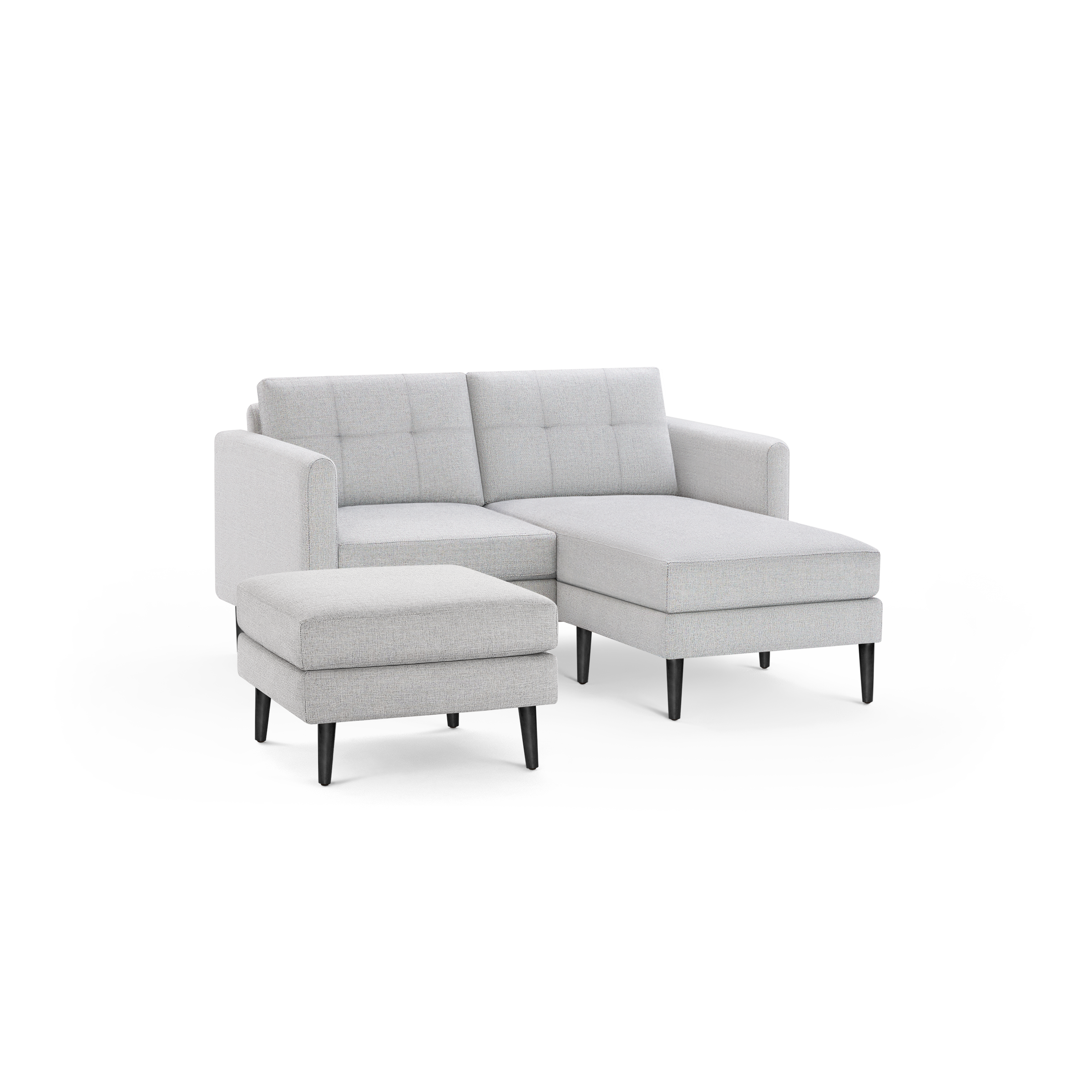 Light gray fabric sectional sofa with tufted back cushions and matching ottoman, featuring black tapered legs.