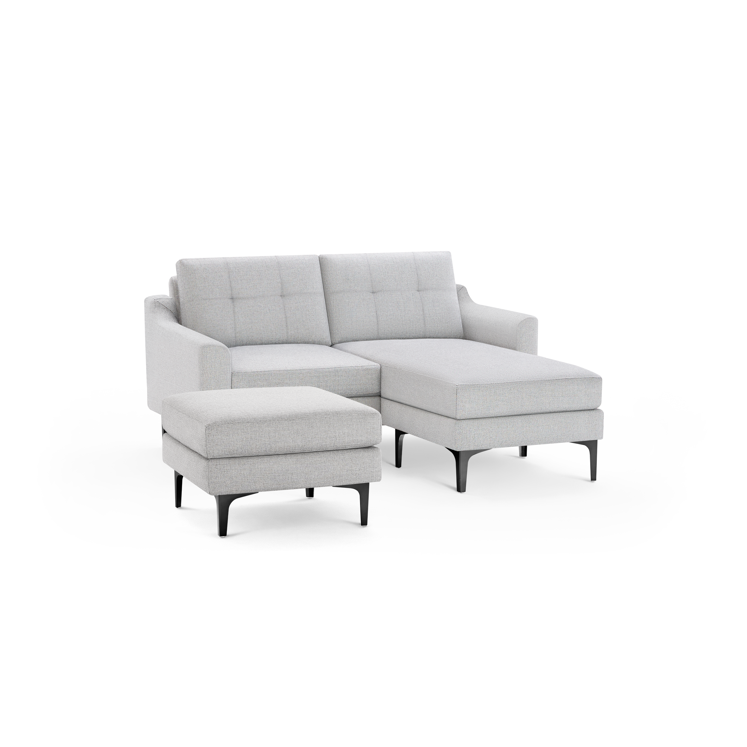 Light gray modern sectional sofa with tufted back cushions, clean lines, and a matching cushioned ottoman on black legs.