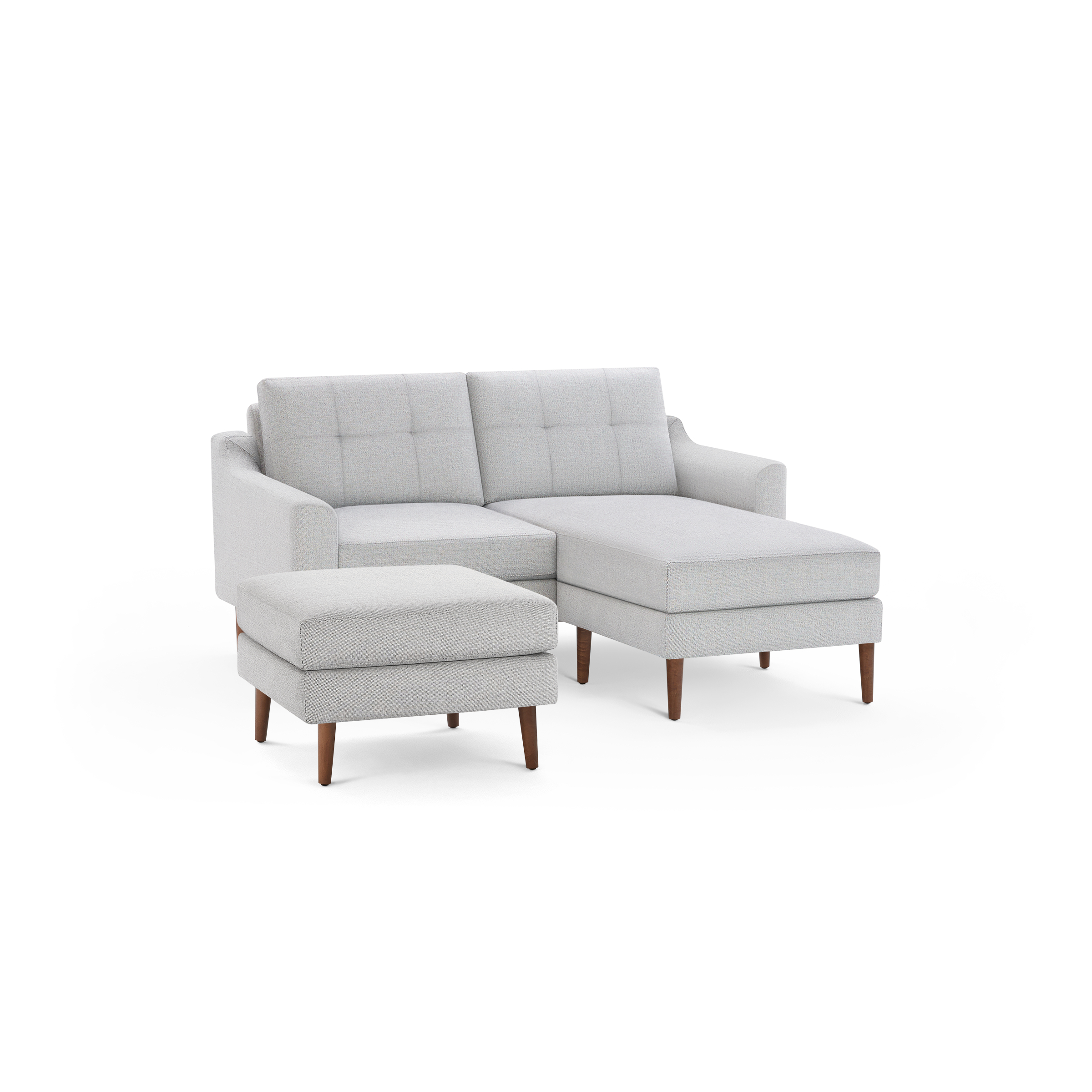 Light gray sectional sofa with tufted back cushions and wooden legs, featuring a chaise and matching ottoman.