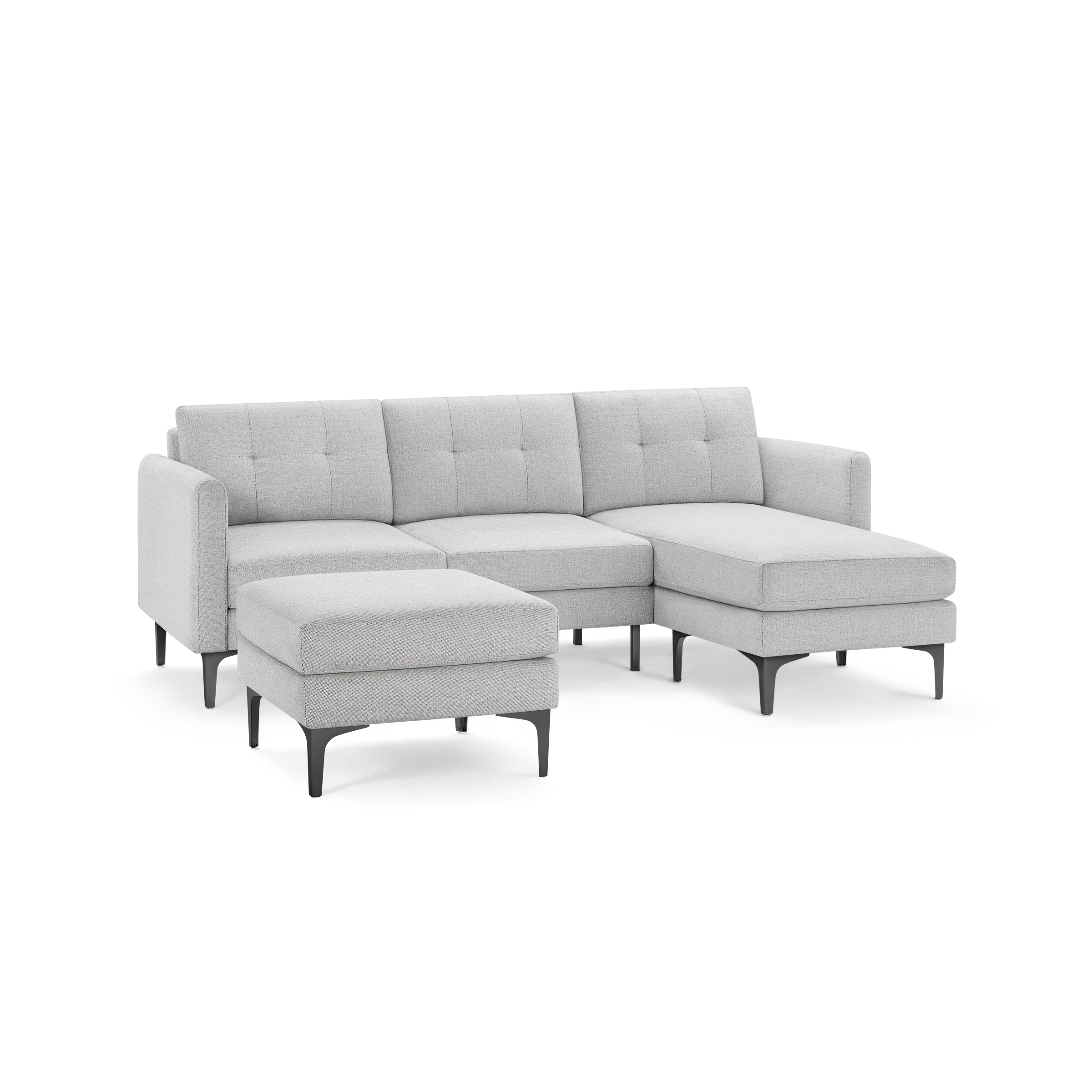 Light grey fabric sectional sofa with tufted back cushions, chaise lounge, and matching ottoman on black legs.