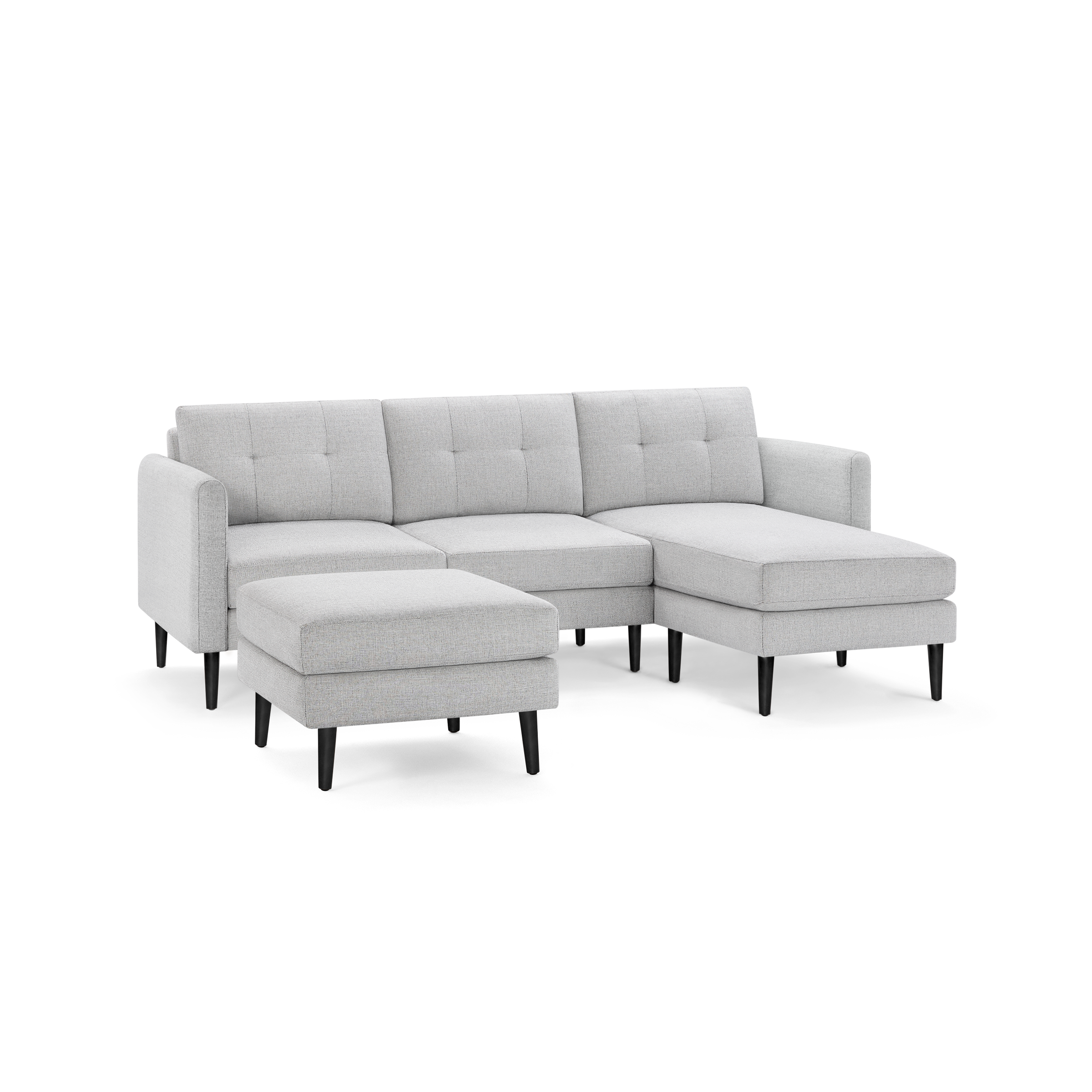 Light gray fabric sectional sofa with tufted back cushions, dark wooden legs, and a matching ottoman.