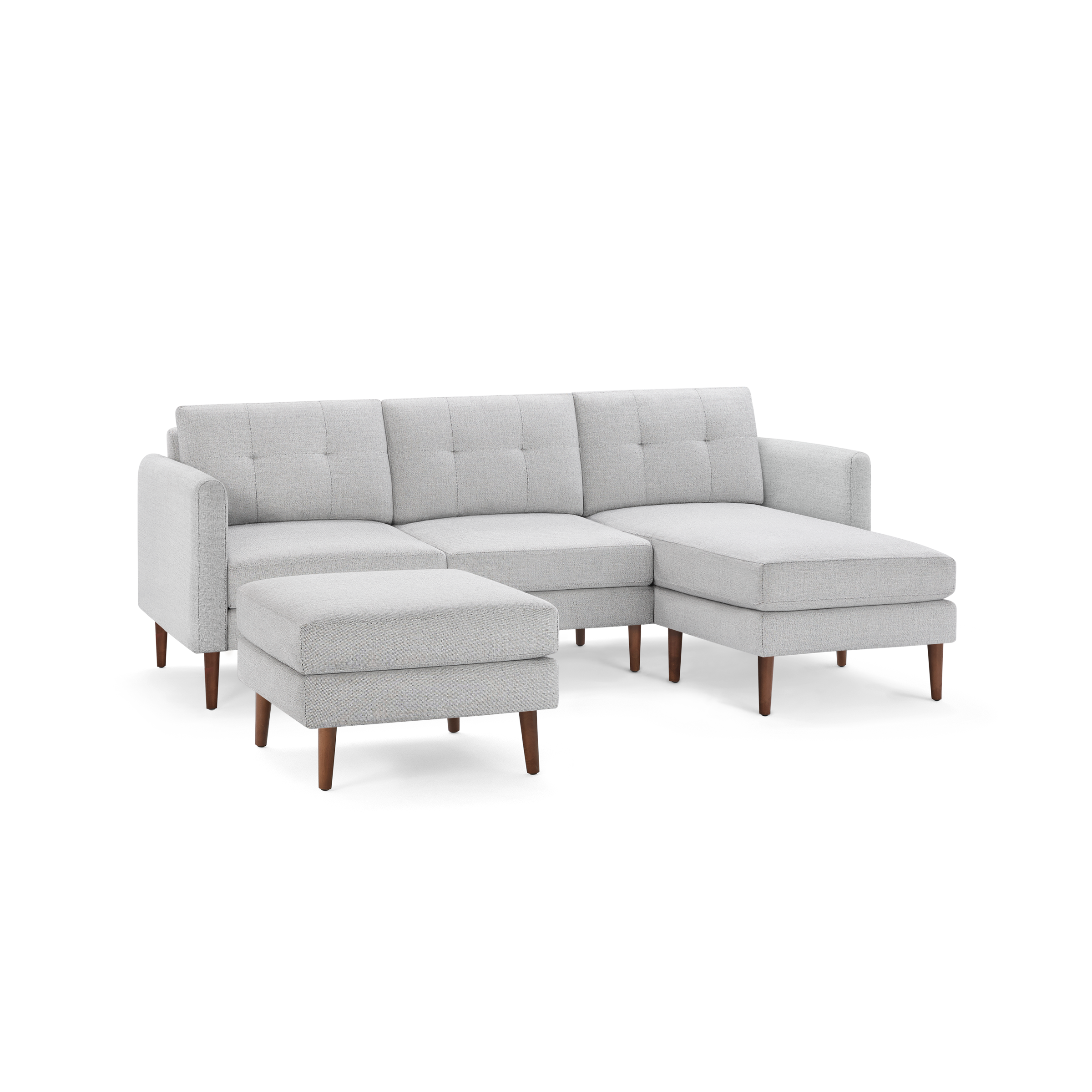 Light gray sectional sofa with tufted cushions, wooden legs, and a matching ottoman, designed for modern living rooms.