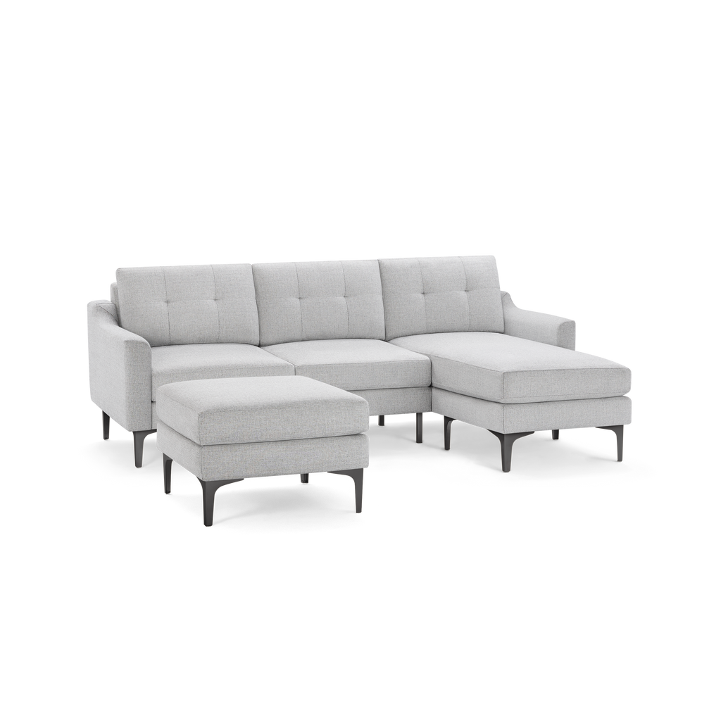 Modern light gray sectional sofa with tufted back cushions, metal legs, and a matching square ottoman.