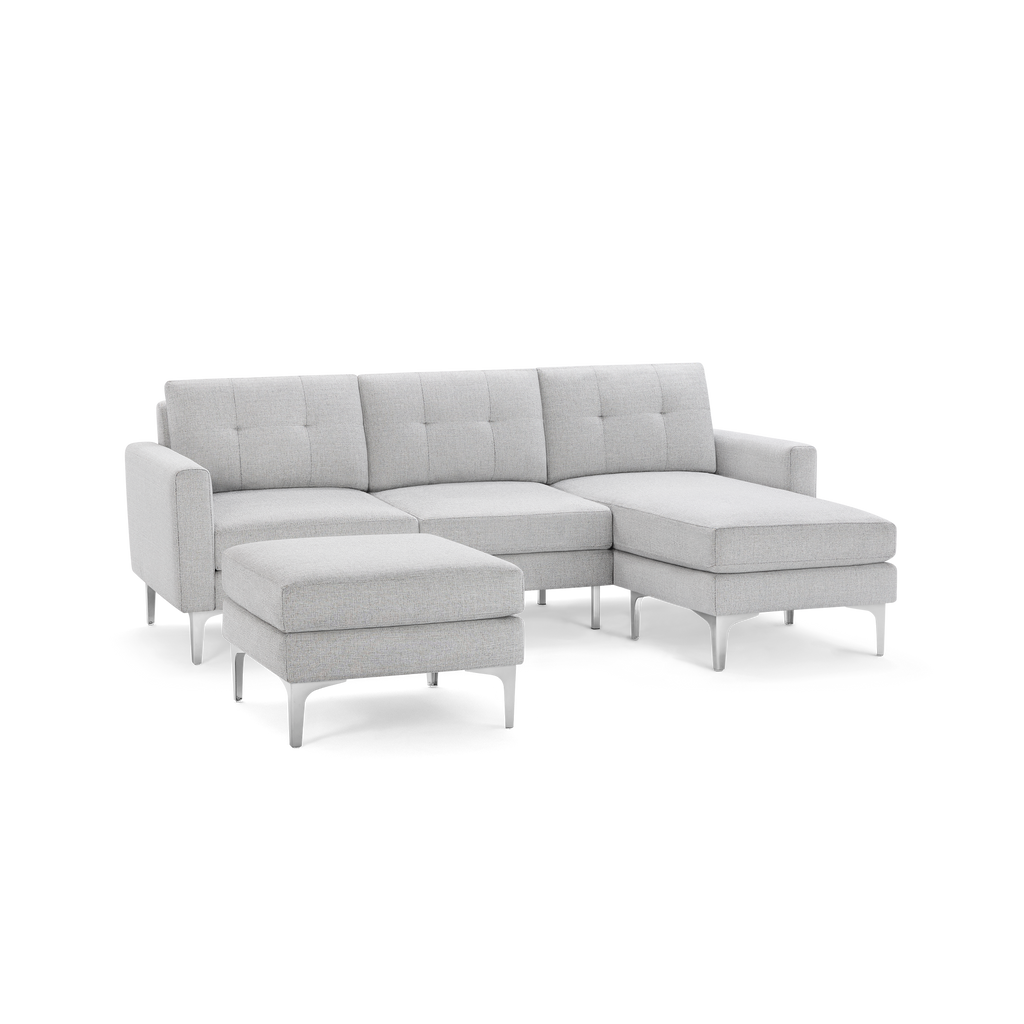 Light gray modern sectional sofa with tufted cushions, metal legs, right chaise, and matching ottoman.