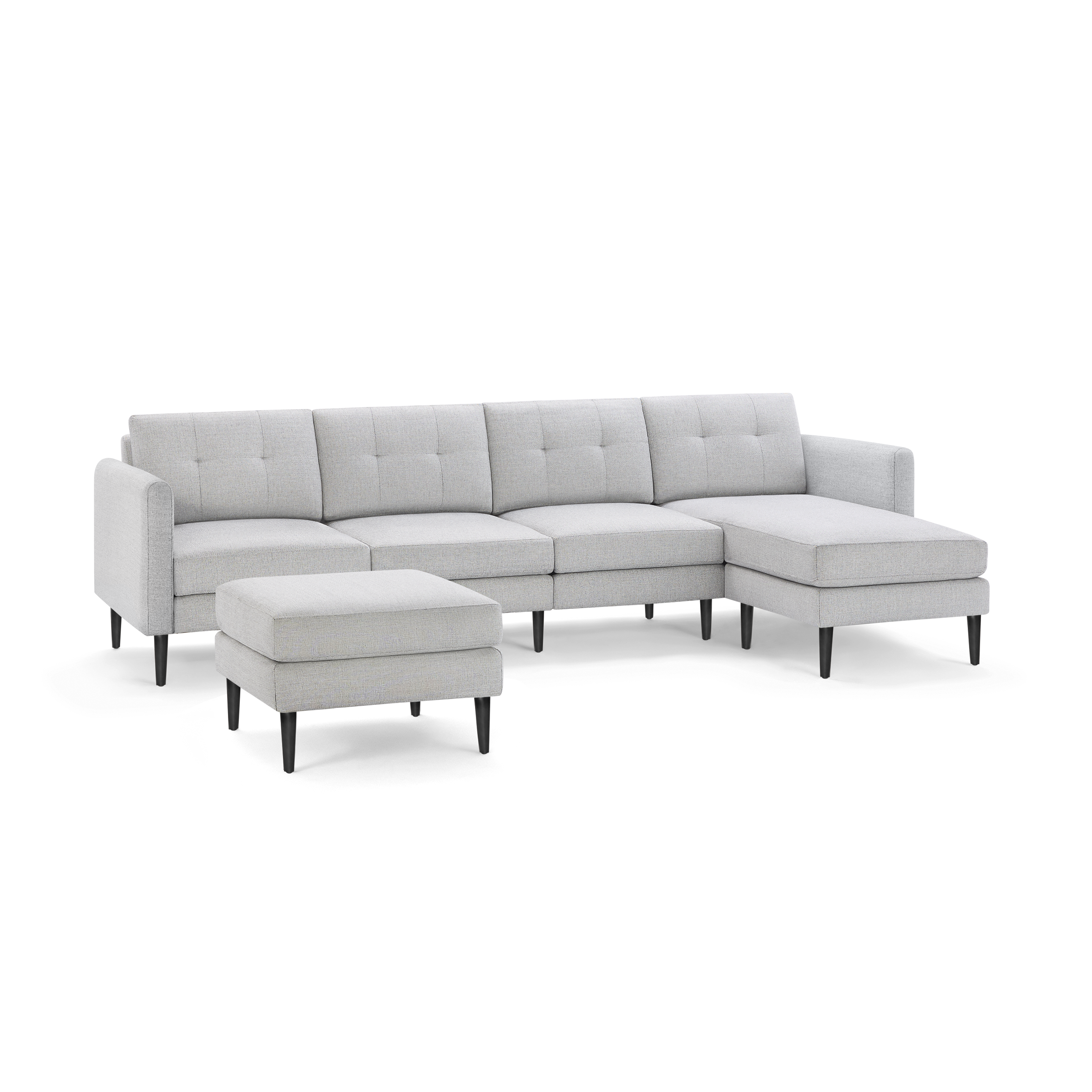 Light gray modern sectional sofa with tufted back cushions, black tapered legs, and matching ottoman on plain background.