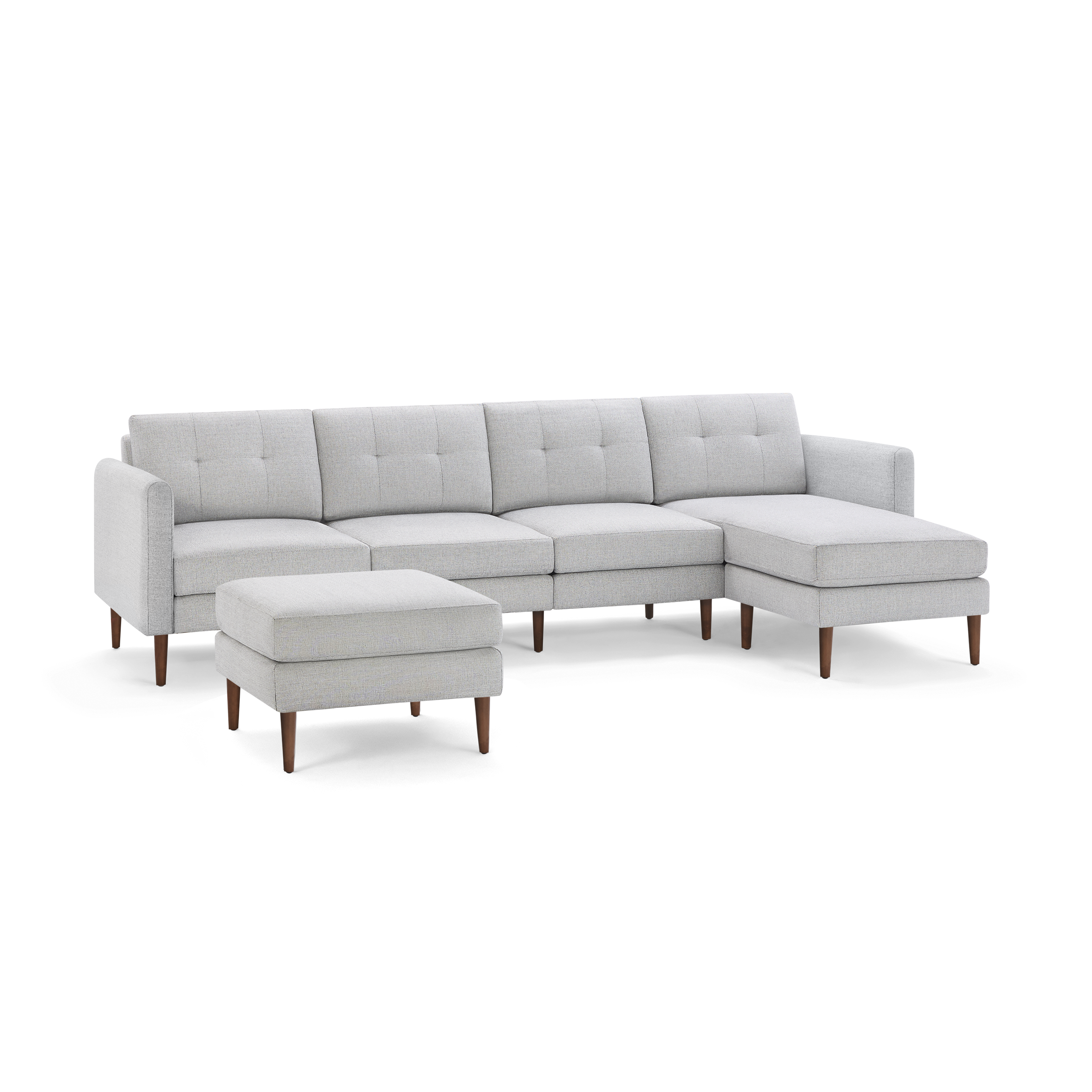 Light gray modern sectional sofa with tufted cushions, wooden legs, and a matching rectangular ottoman on black background.
