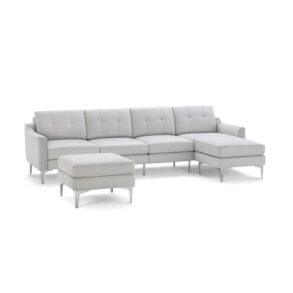 Light gray modern sectional sofa with tufted back cushions, metal legs, and a separate matching ottoman.