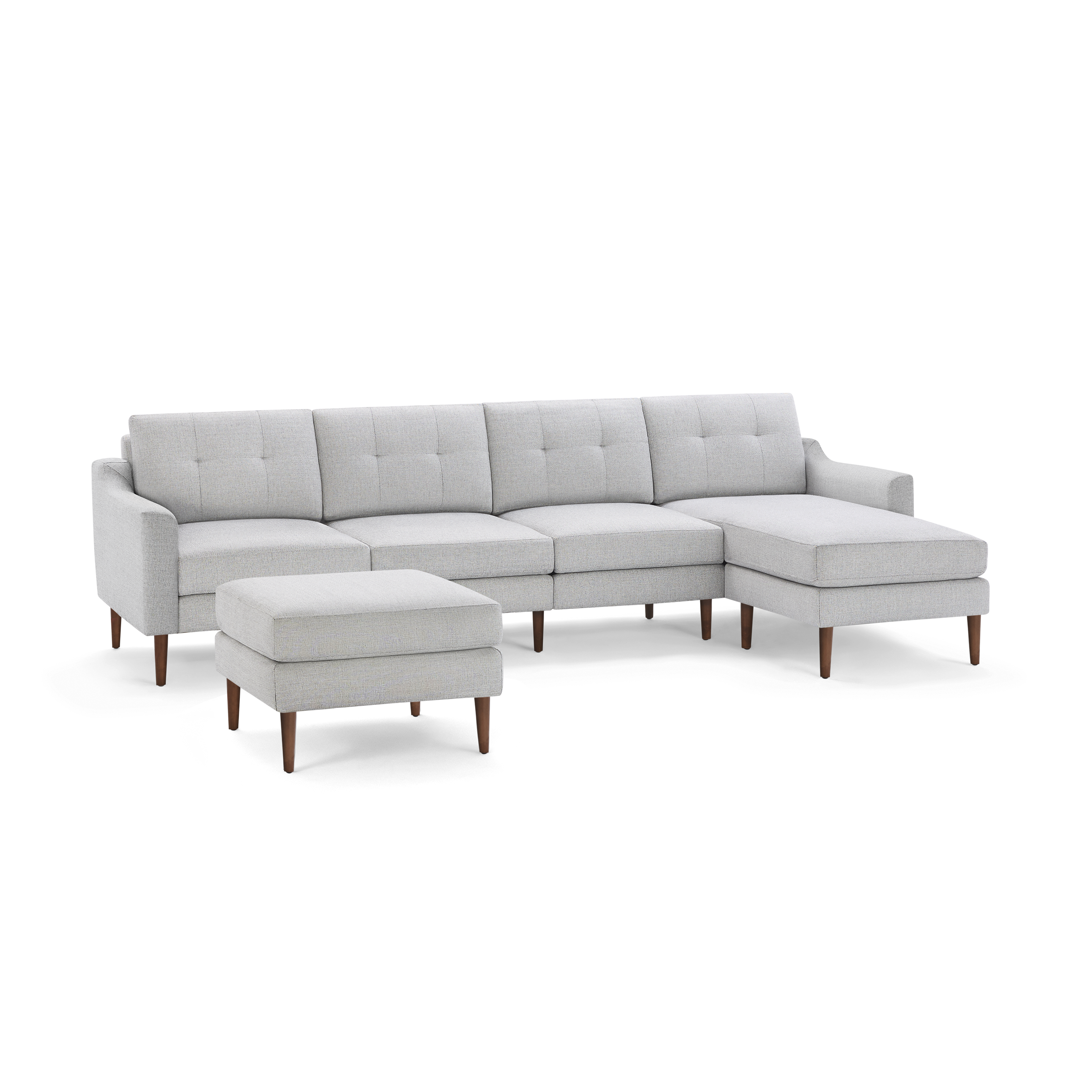 Light gray modern sectional sofa with tufted back cushions, wooden legs, and matching ottoman on a black background.