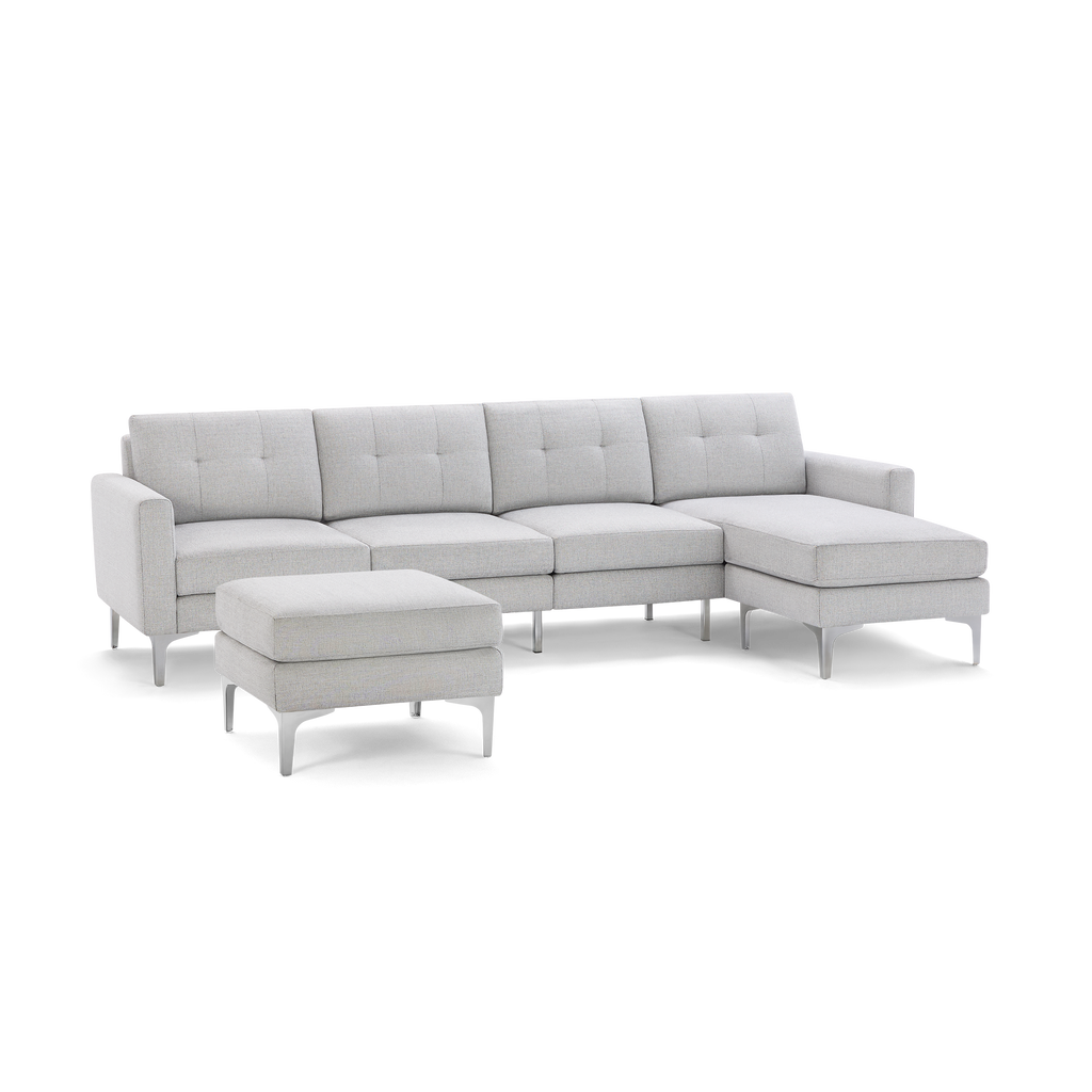 Light gray fabric sectional sofa with tufted cushions, a right chaise, and a matching square ottoman on silver legs.