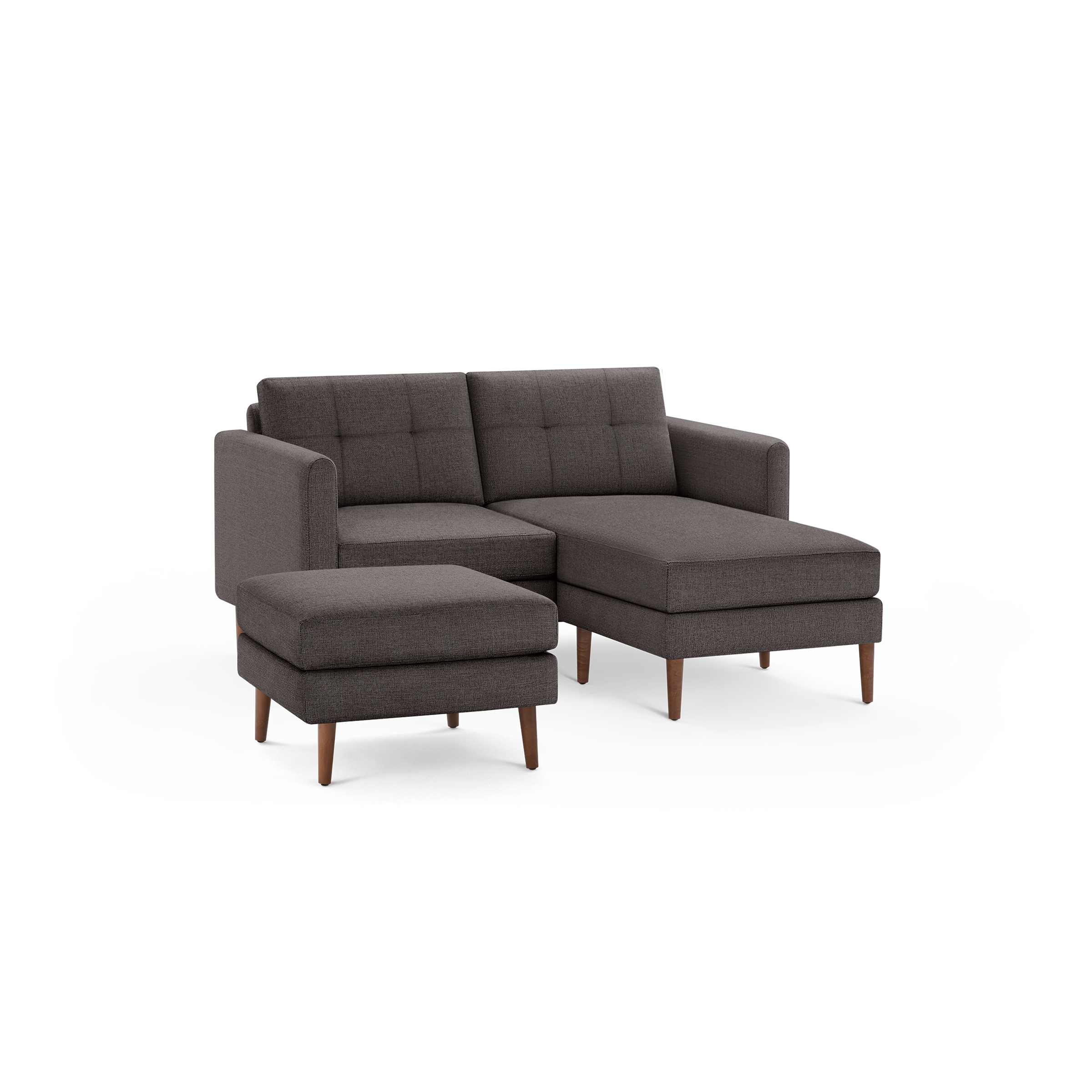 Dark gray fabric sectional sofa with tufted back cushions, wooden legs, and a matching ottoman.