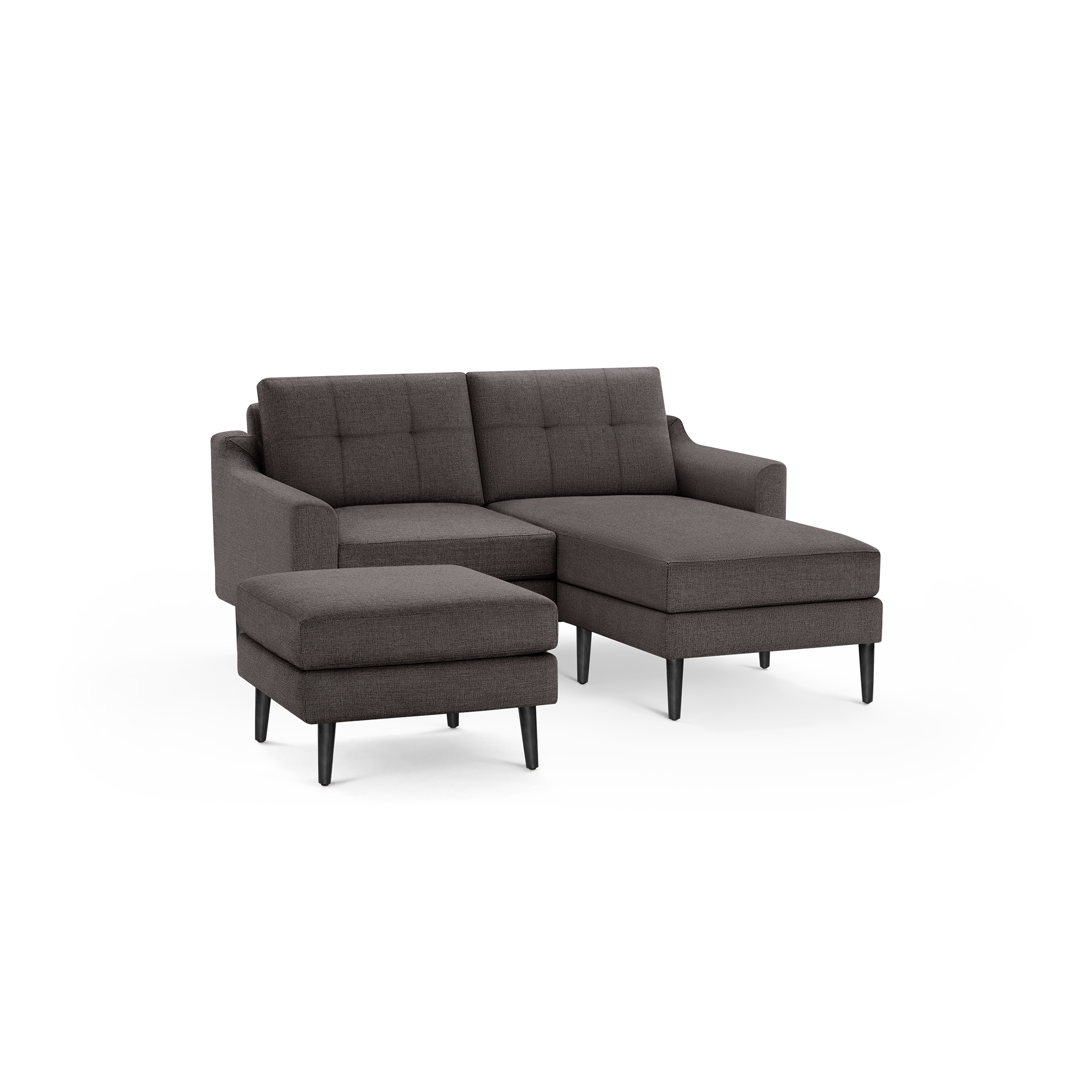 Dark gray fabric sectional sofa with tufted back cushions, matching ottoman, and black tapered legs, modern design.