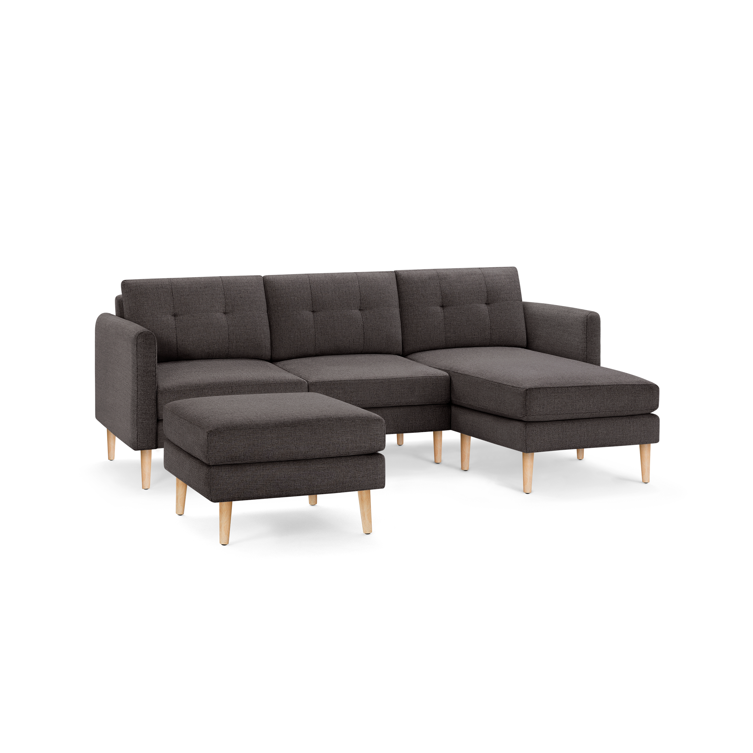 Modern dark gray fabric sectional sofa with tufted cushions, wooden legs, and a matching ottoman.