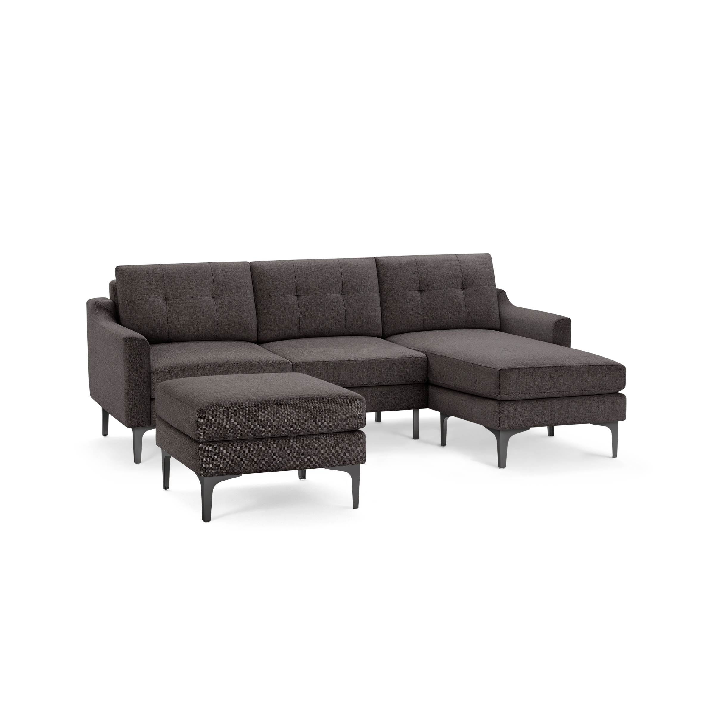 Dark gray modern sectional sofa with tufted cushions, metal legs, and a matching ottoman isolated on white background.