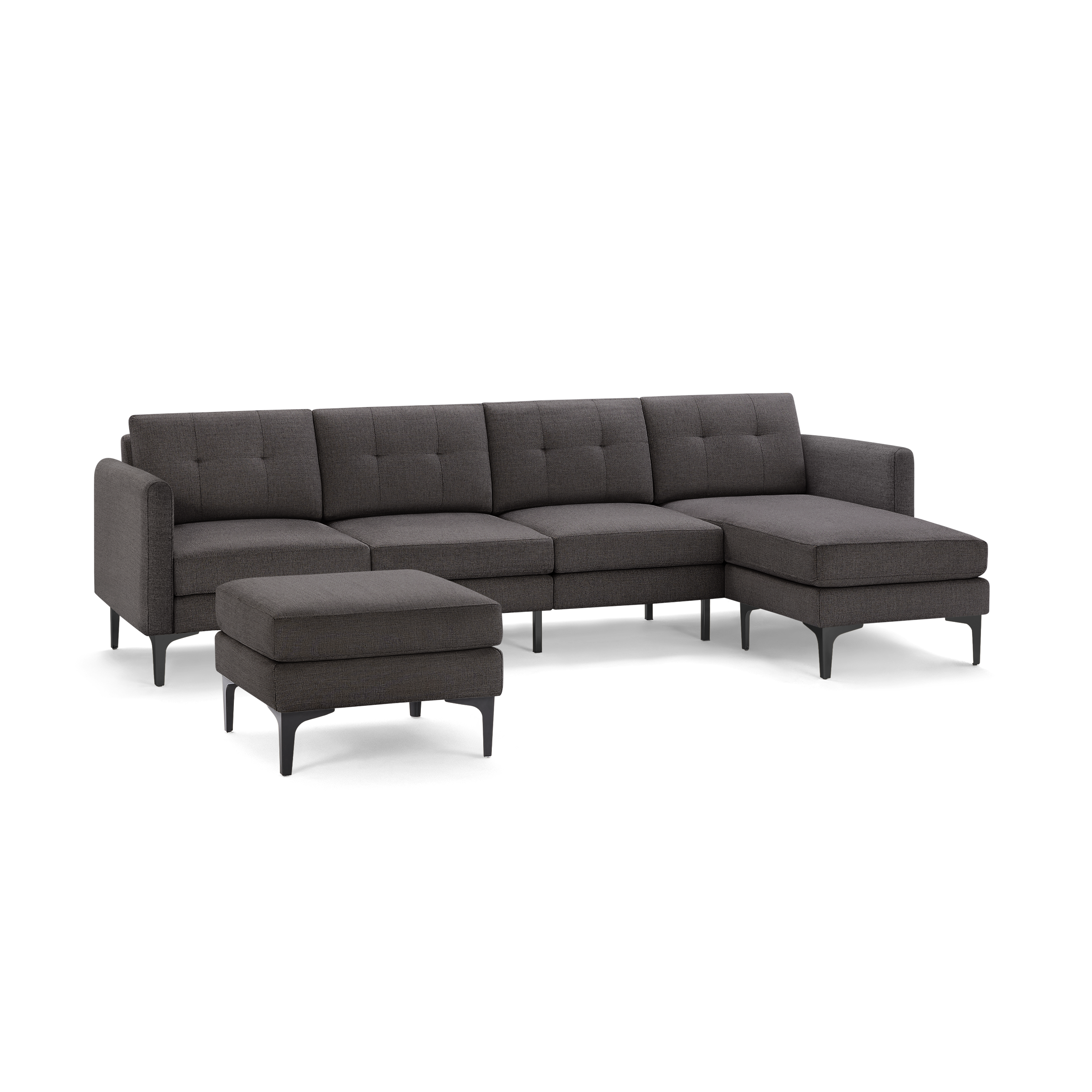 Dark gray fabric sectional sofa with chaise lounge and matching ottoman, featuring tufted back cushions and modern black metal legs.