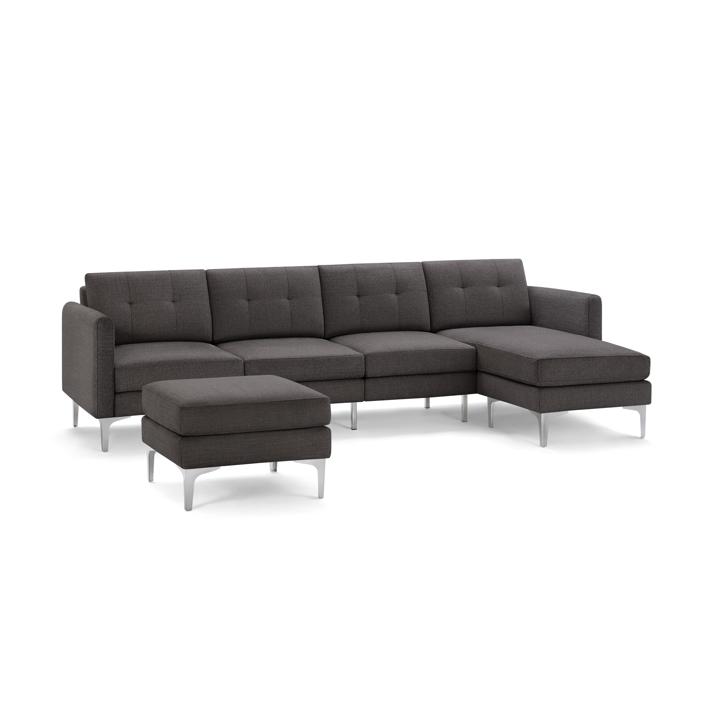 Dark gray L-shaped sectional sofa with tufted cushions and matching ottoman, featuring sleek metal legs.