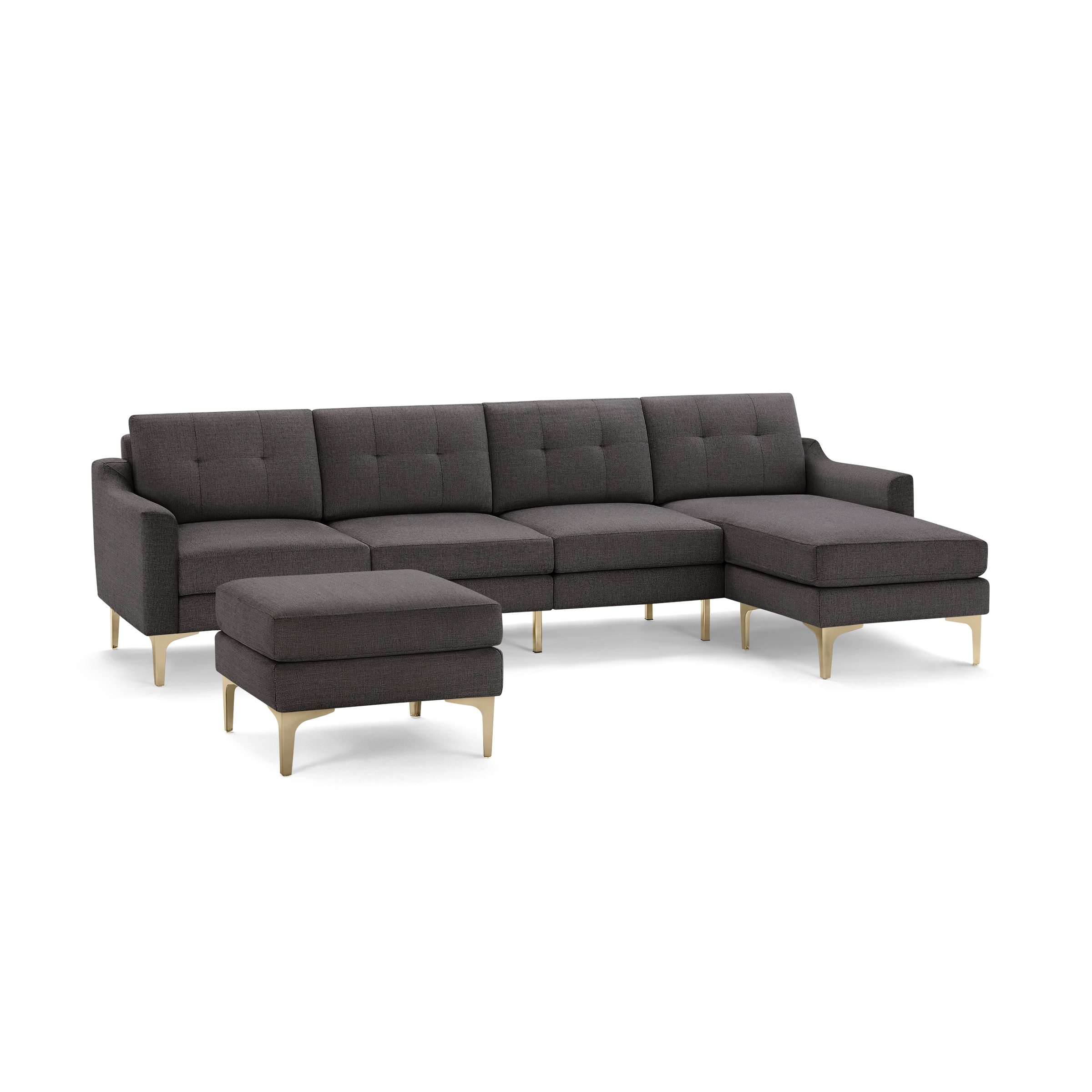 Dark gray fabric sectional sofa with tufted back cushions, slim angled gold legs, and matching ottoman.