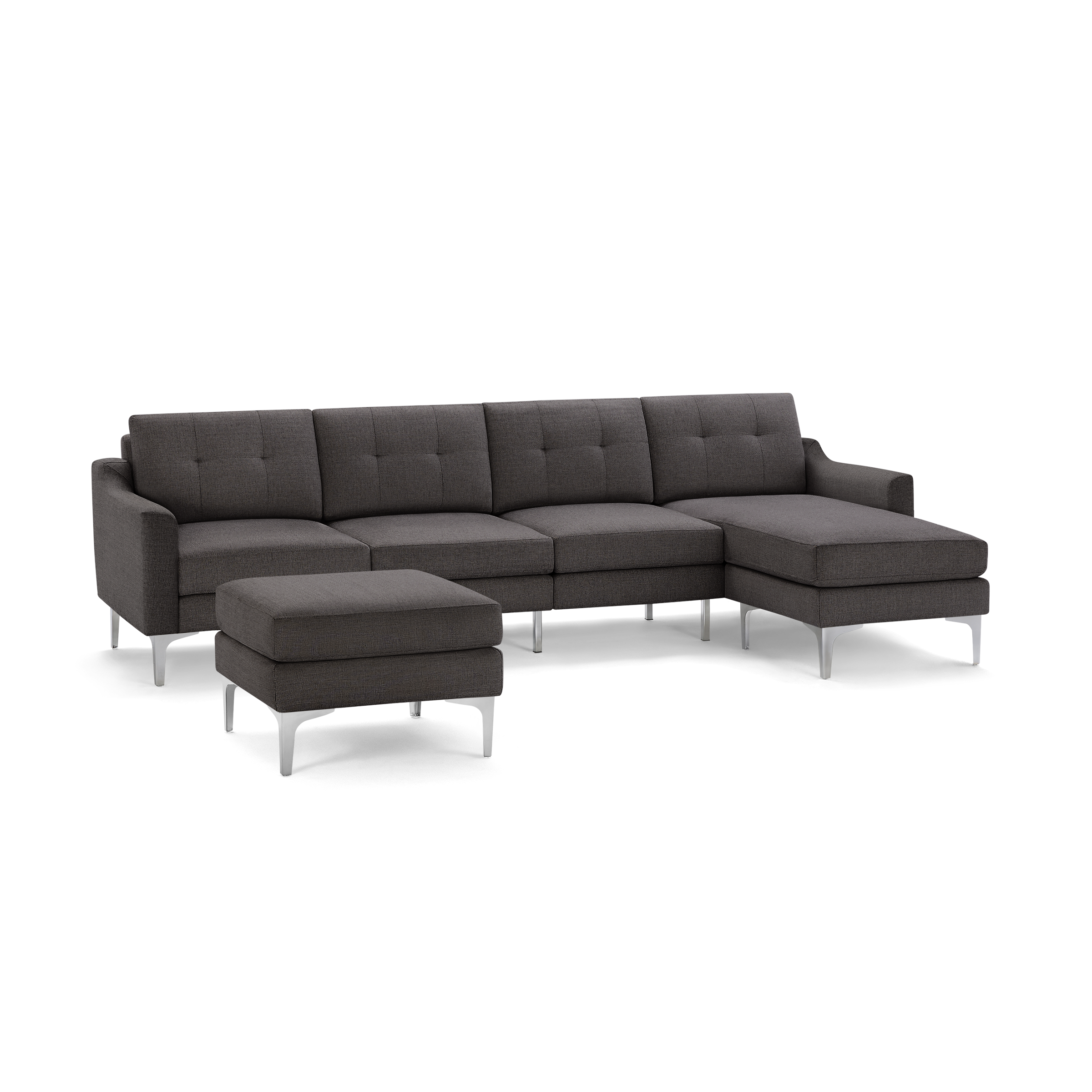 Modern dark gray fabric sectional sofa with tufted cushions, metal legs, and matching ottoman on black background.