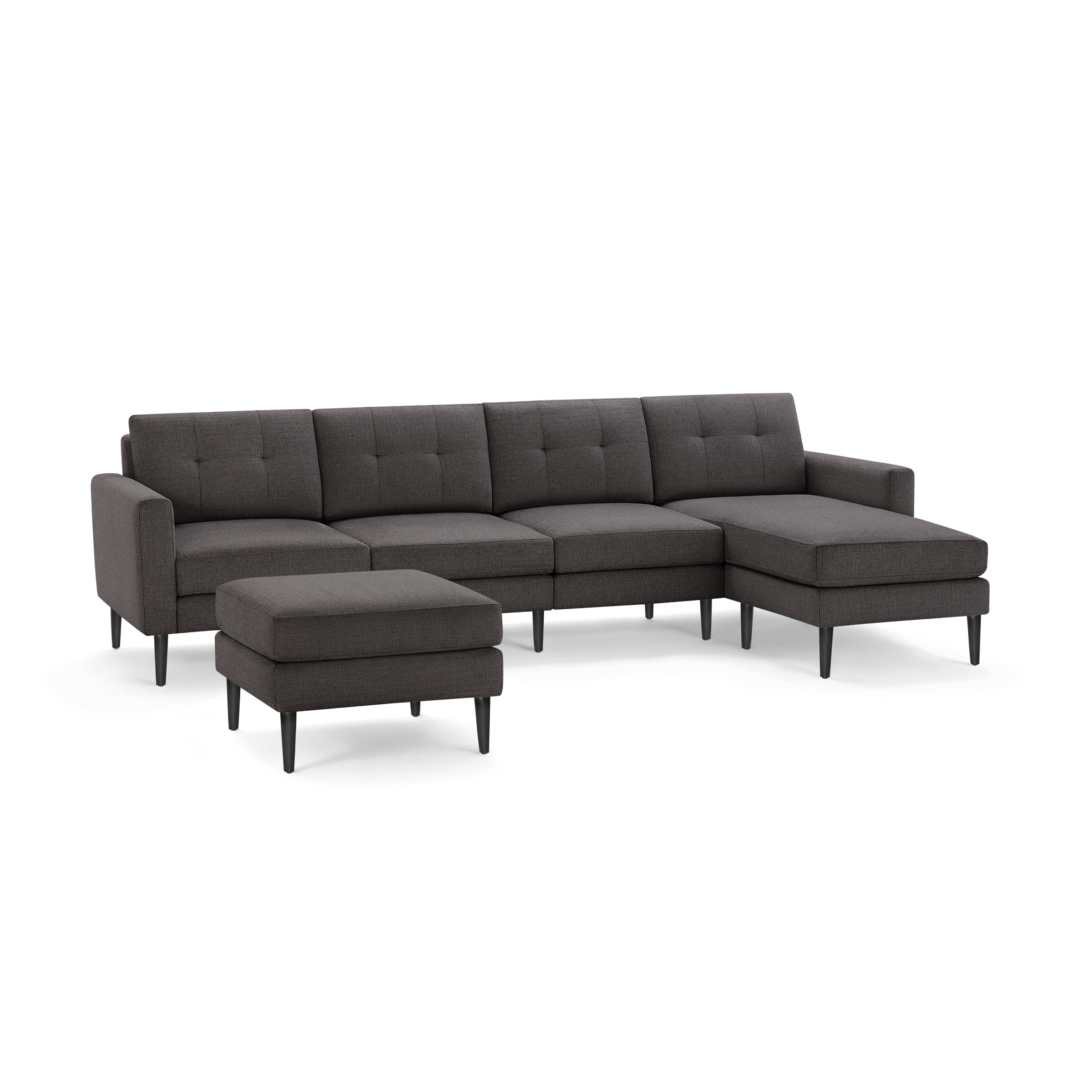 Dark gray L-shaped sectional sofa with tufted cushions and matching ottoman, featuring sleek black legs.