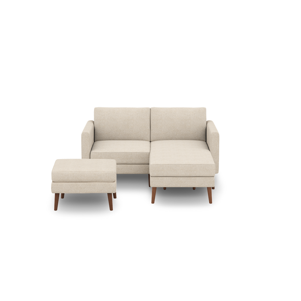 Beige modern sectional sofa with a matching ottoman, featuring wooden legs and clean, minimalist design.