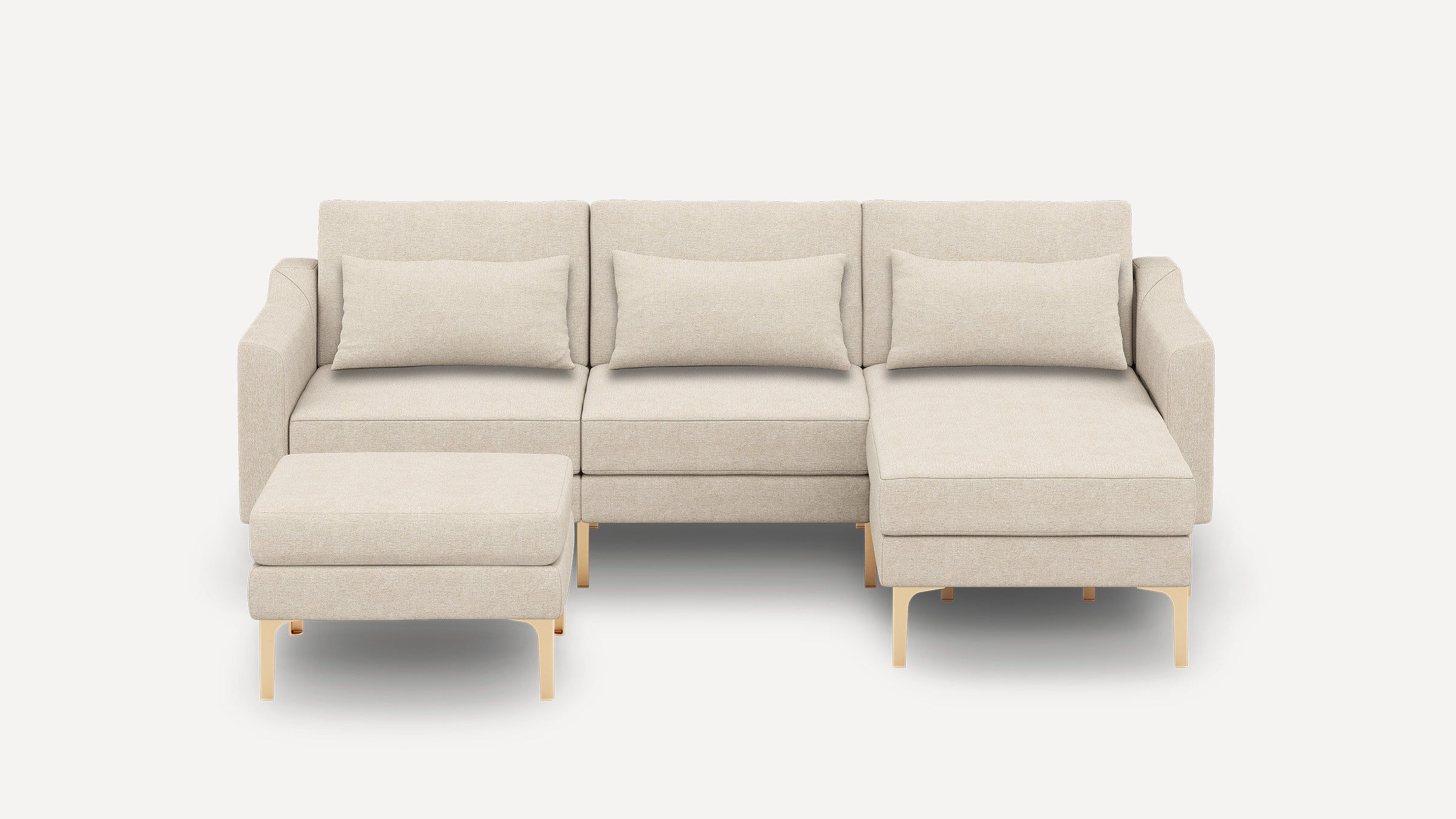 Beige modern sectional sofa with three back cushions, two armrests, a chaise lounge on the right, and a matching ottoman with metallic legs.
